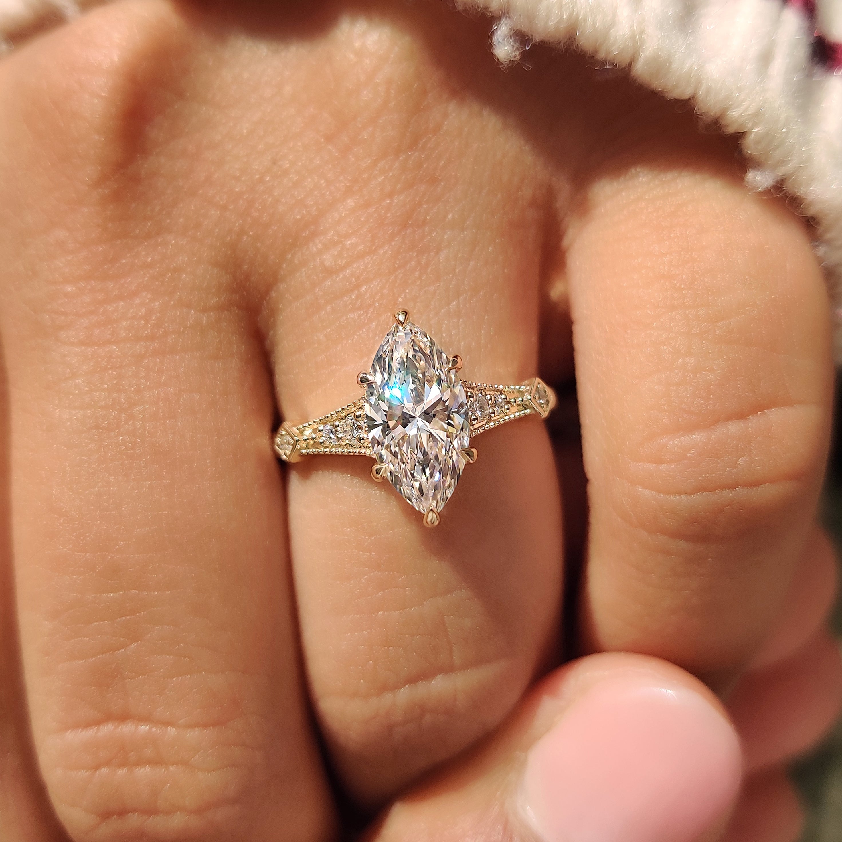 Marquise cut diamond ring with round sides and milgrain
