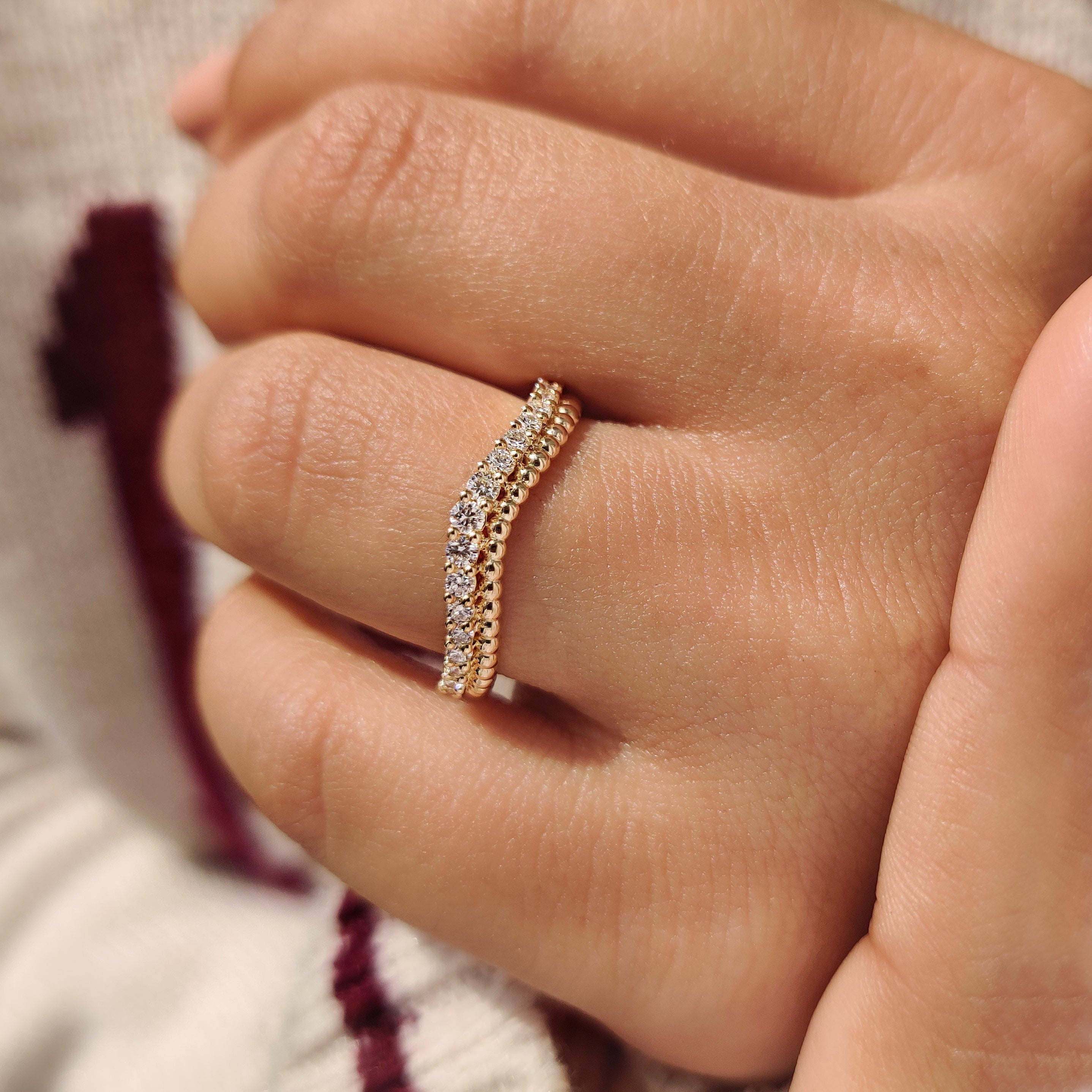 Handmade curved band with shared prong round diamonds.

