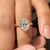 Double side pave band adds brilliance to oval diamond ring.

