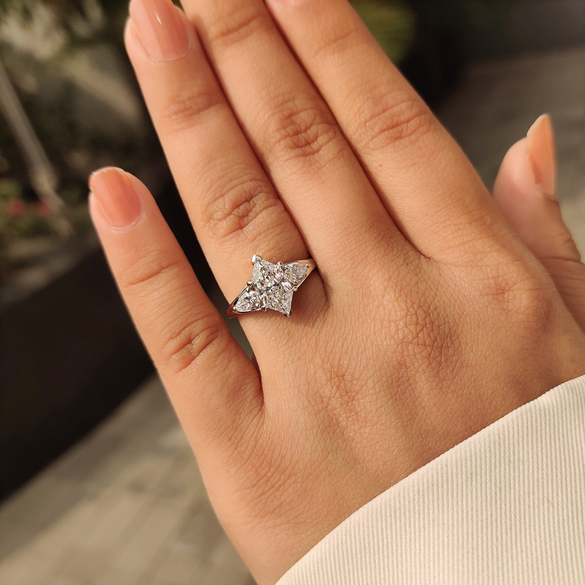 Three stone marquise diamond ring with pear side accents.
