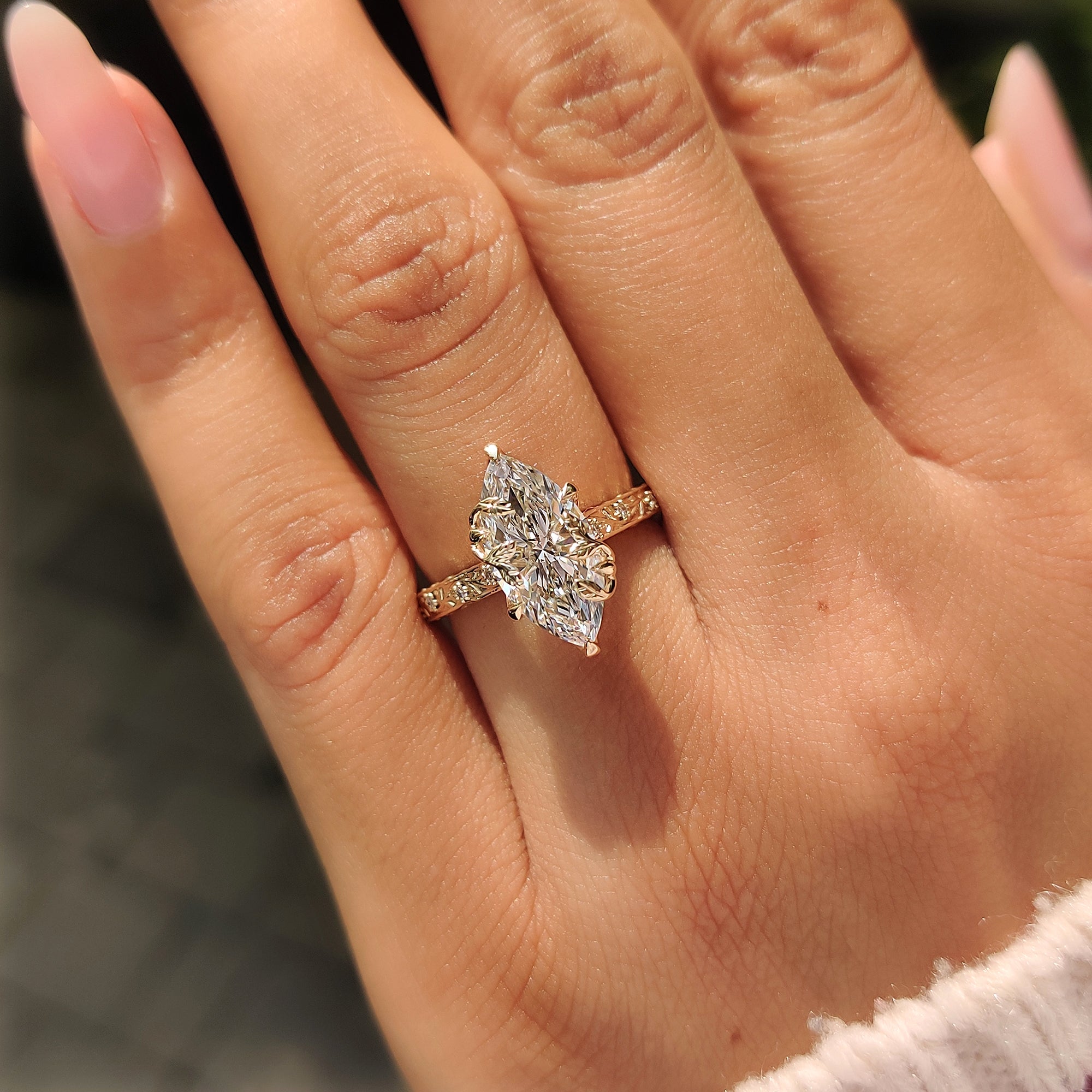 Round diamond accents on marquise engagement ring.

