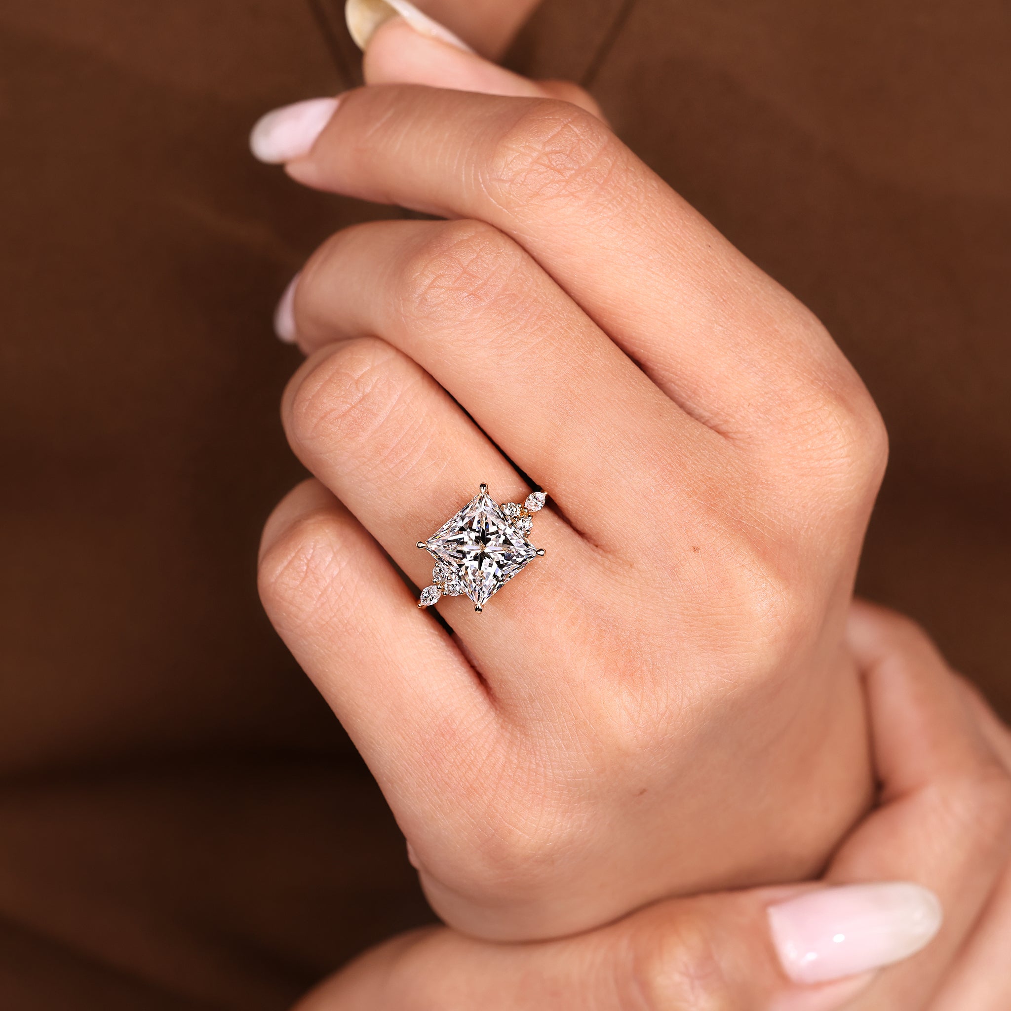 Princess cut diamond ring with balanced seven stone design.
