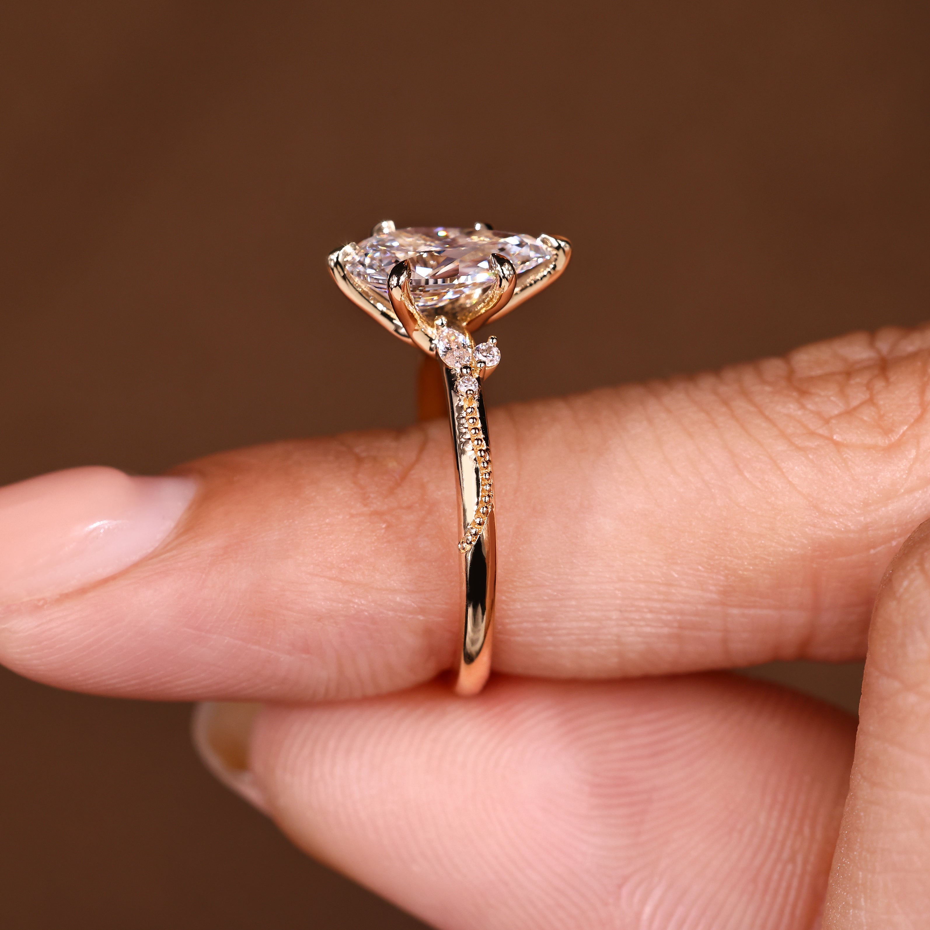 Pear cut diamond ring with round and marquise details
