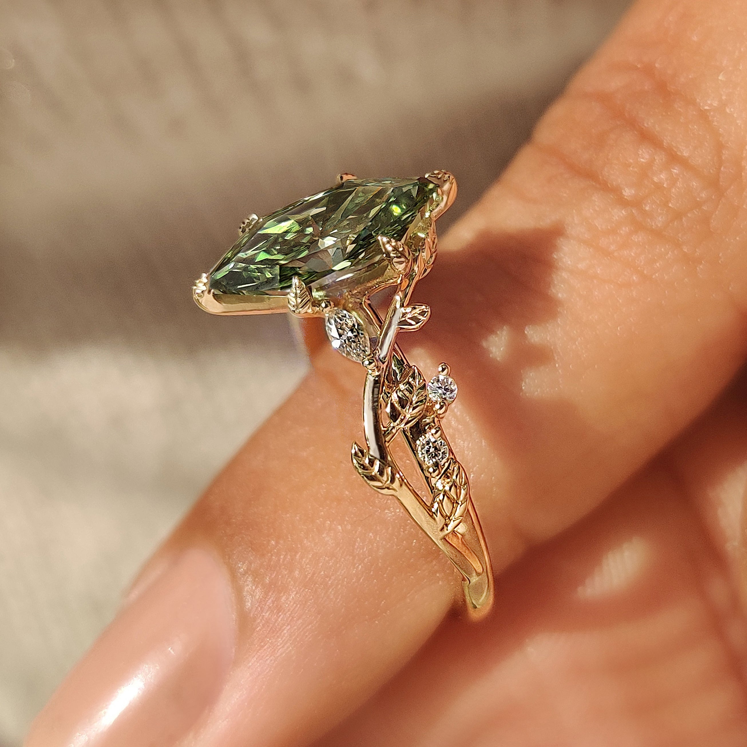 Green diamond ring with six leaf shape prong setting
