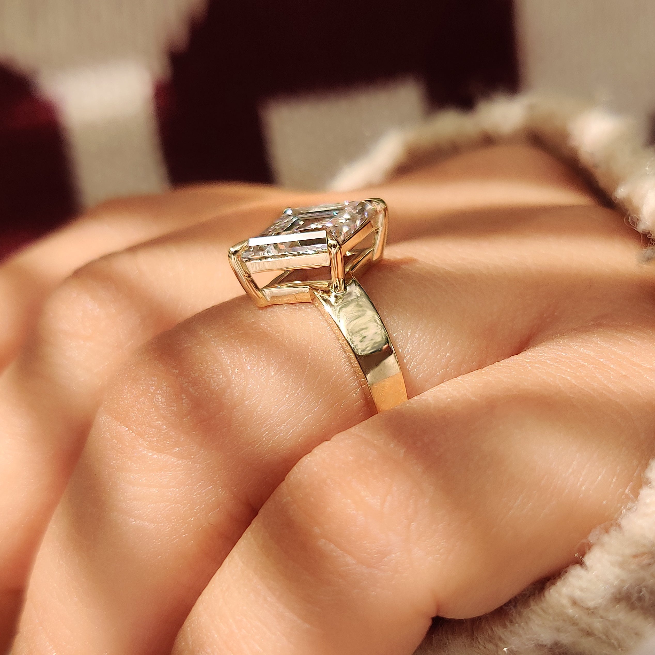 Solitaire lozenge engagement ring with four claw prong setting

