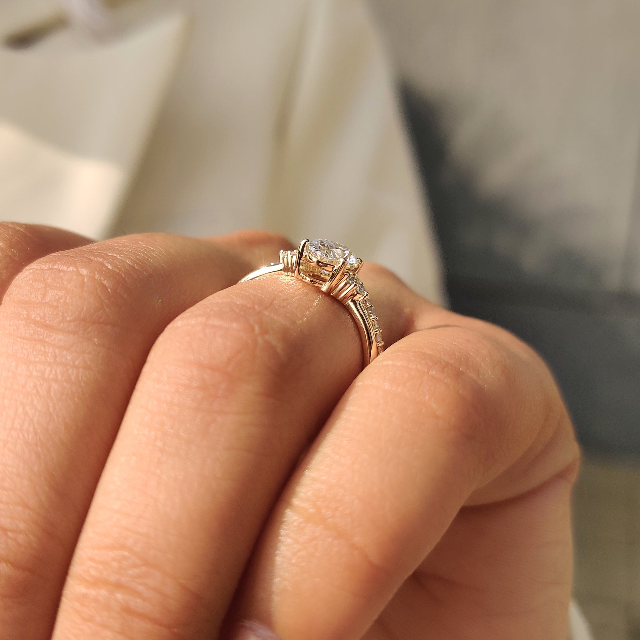 Oval ring with muse setting and curved eternity band.
