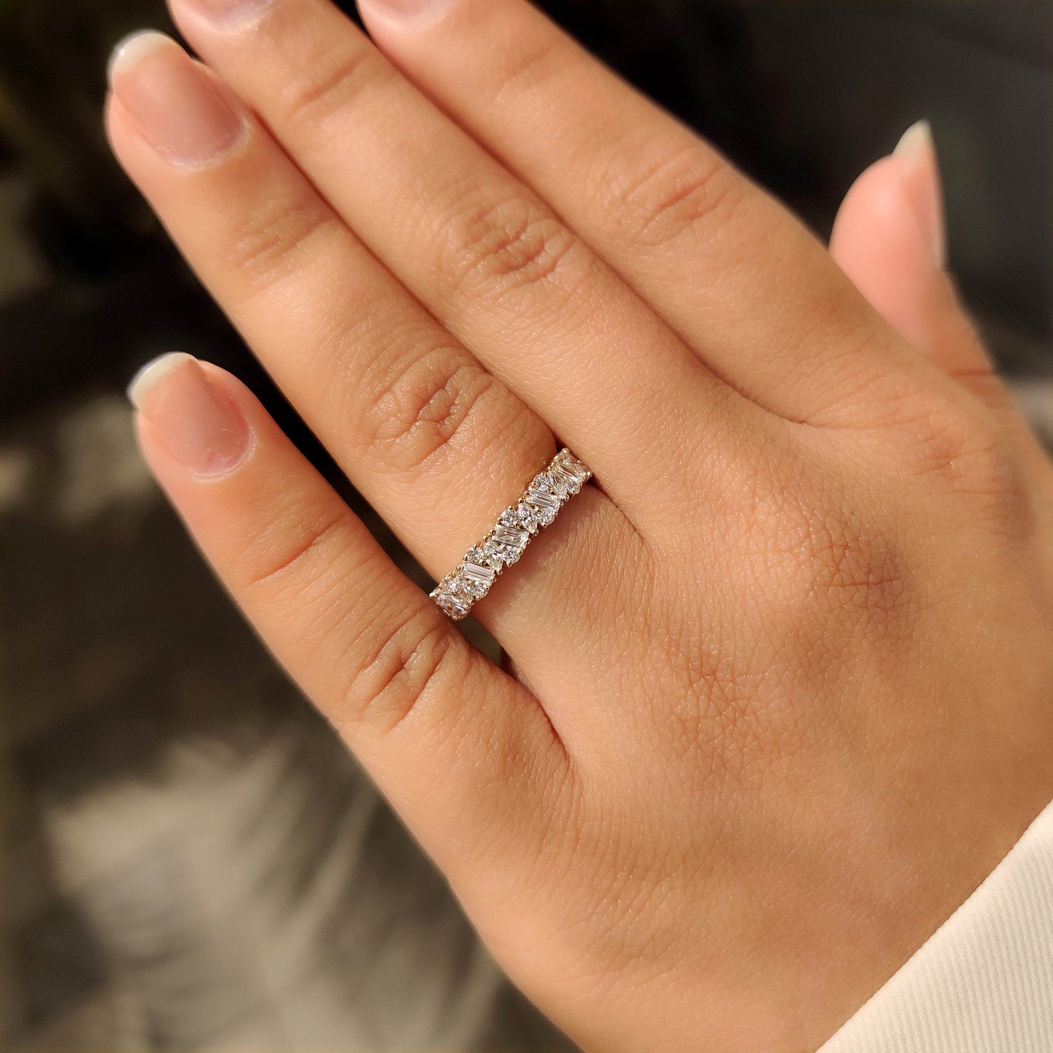 Mixed diamond shapes eternity band with secure prong setting.

