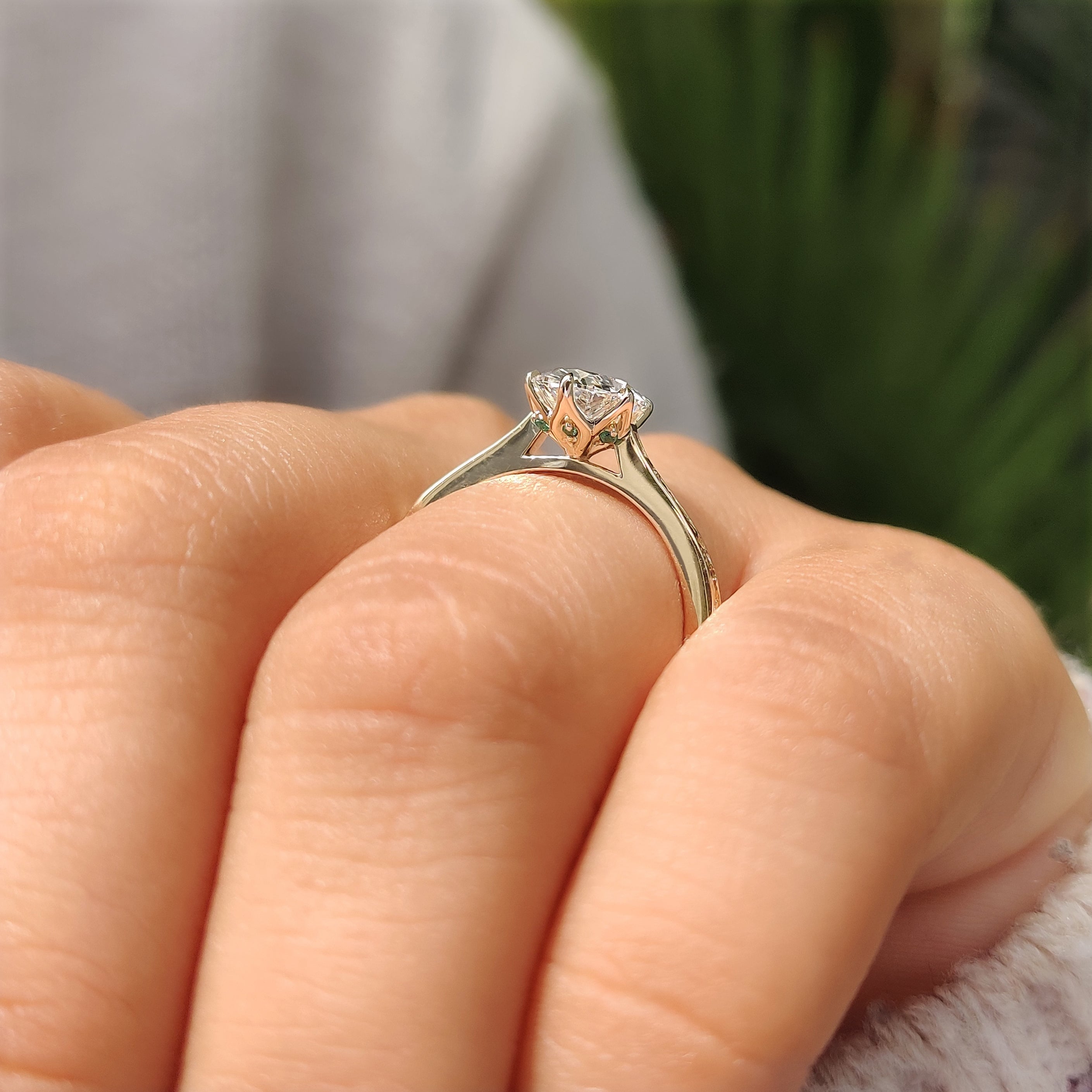 Oval Diamond Ring with Hidden Round Green Emerald Gemstones and Solitaire Setting
