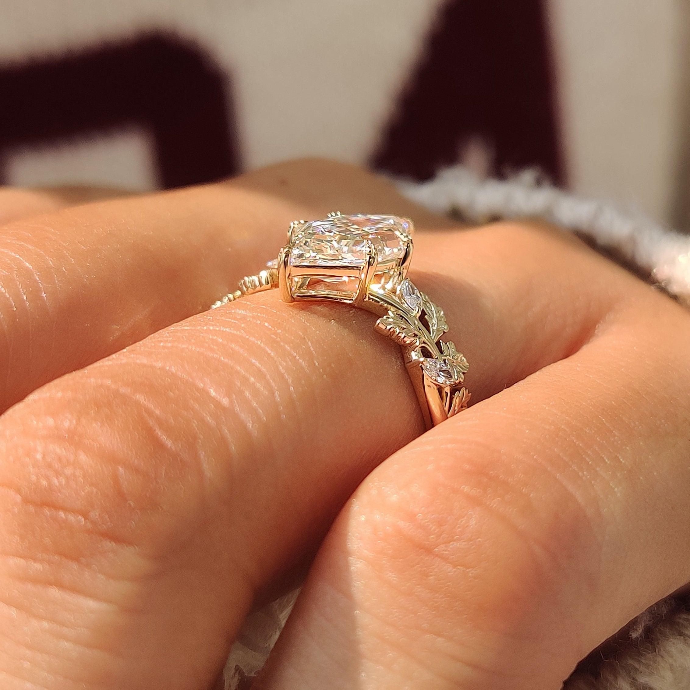 Marquise side stones beside an hexagon step cut center diamond.
