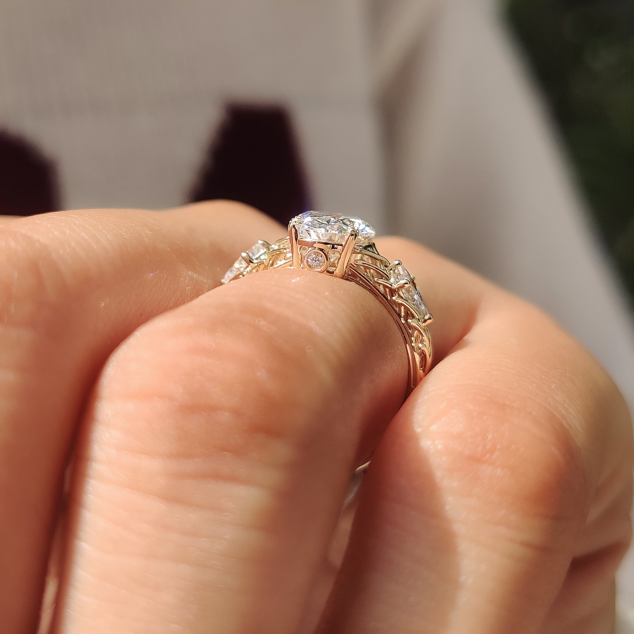 Oval center ring with kite side stones and round accents
