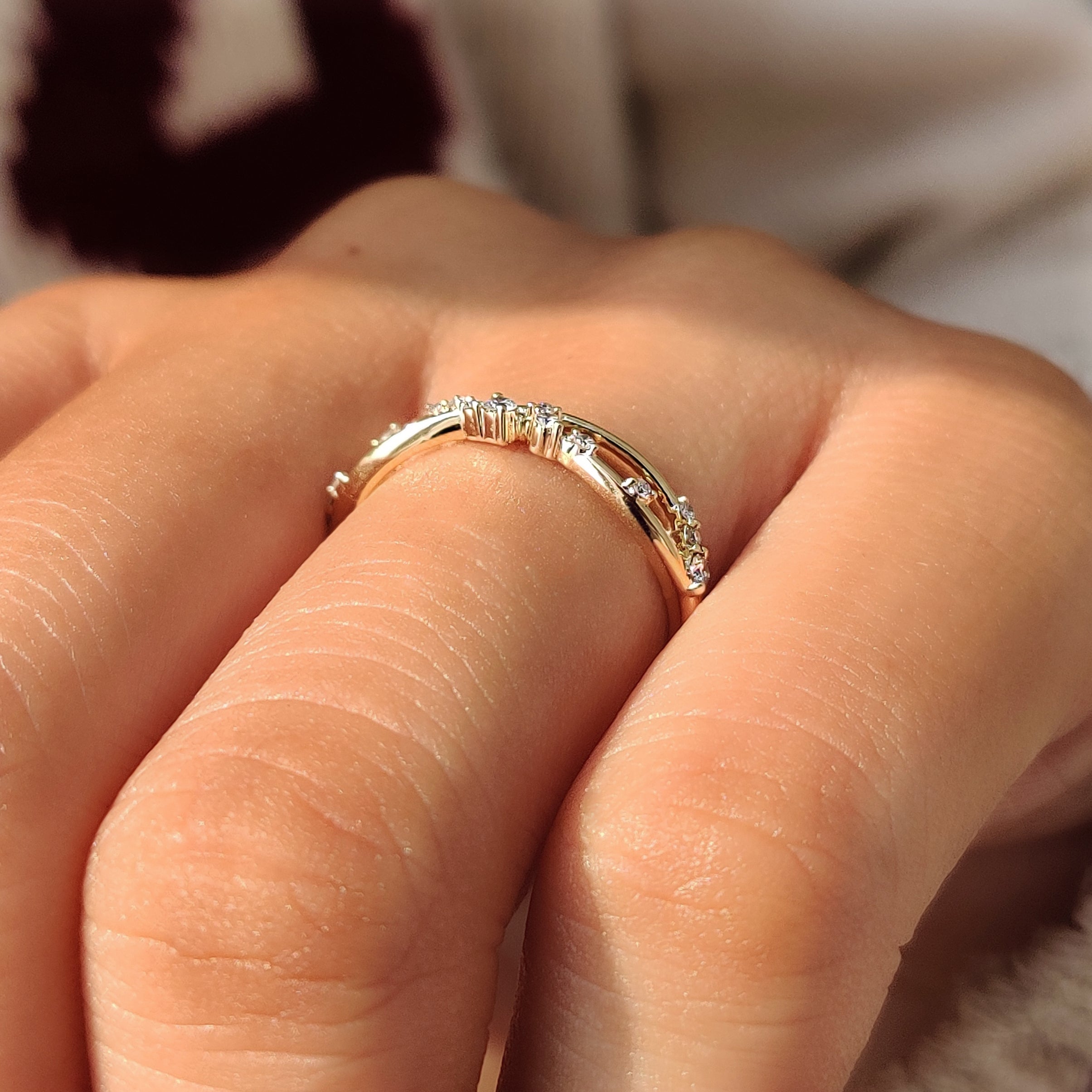 Round diamonds arranged along half of a wedding band.
