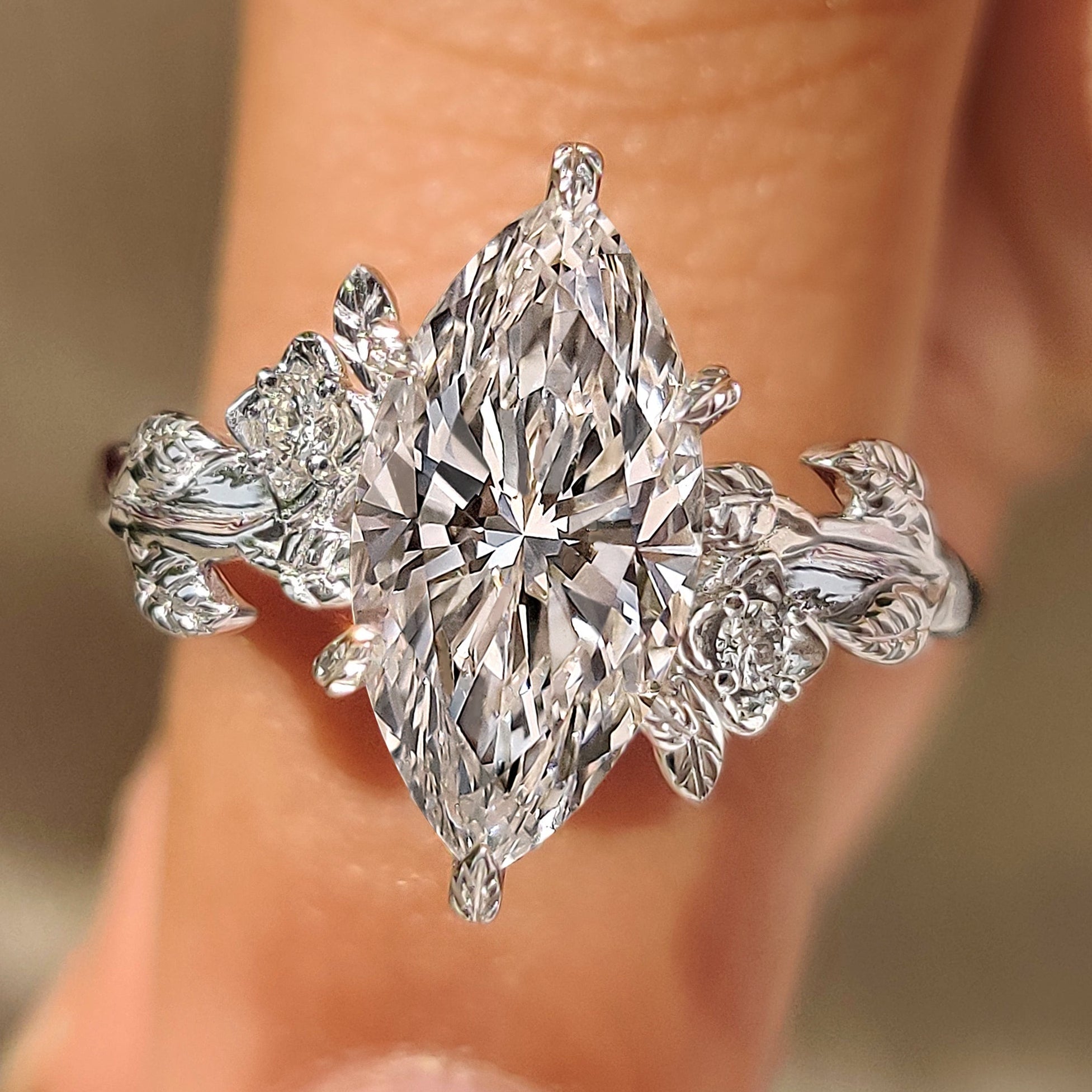 Marquise cut lab grown diamond ring with floral details.
