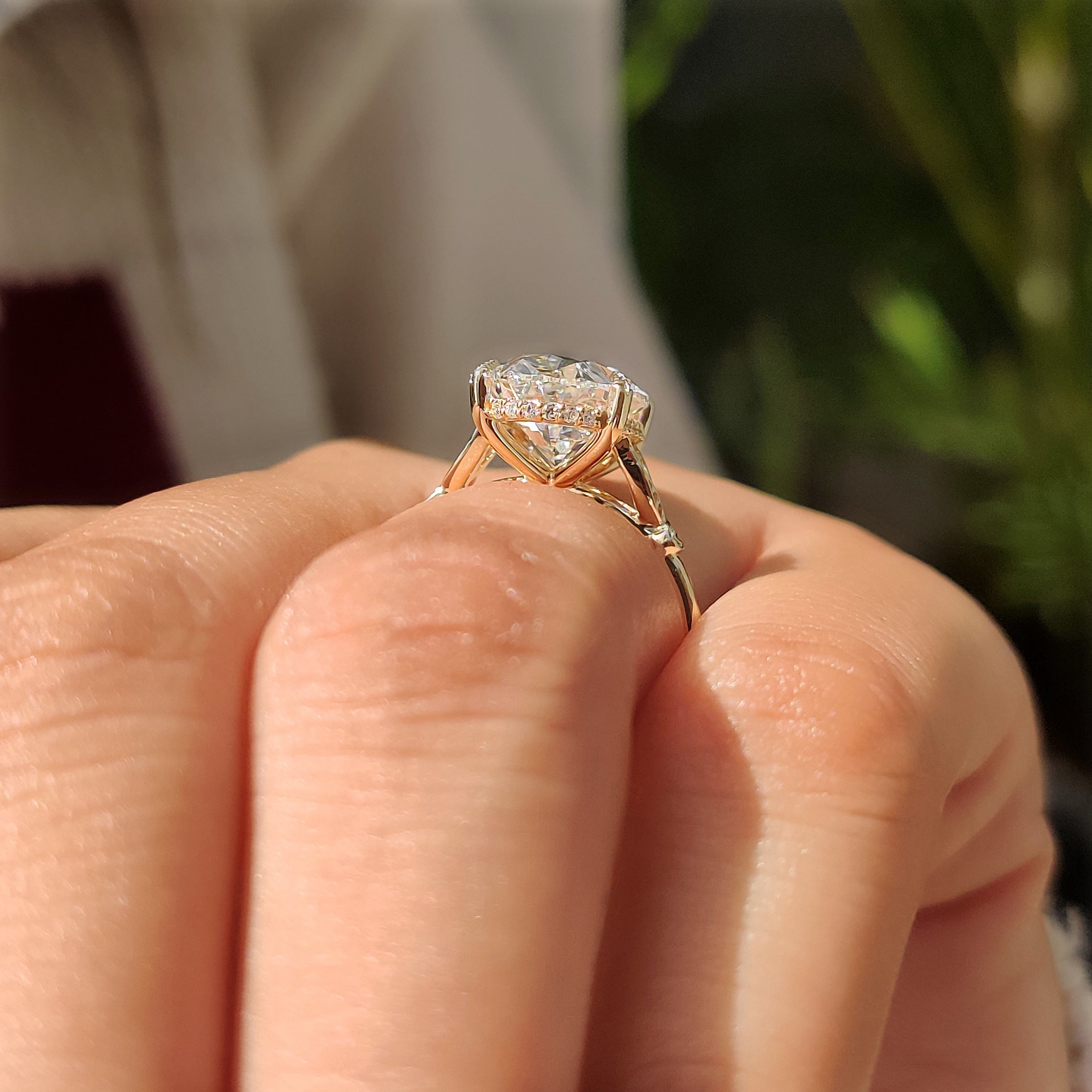 Oval engagement ring with four leaf style prongs
