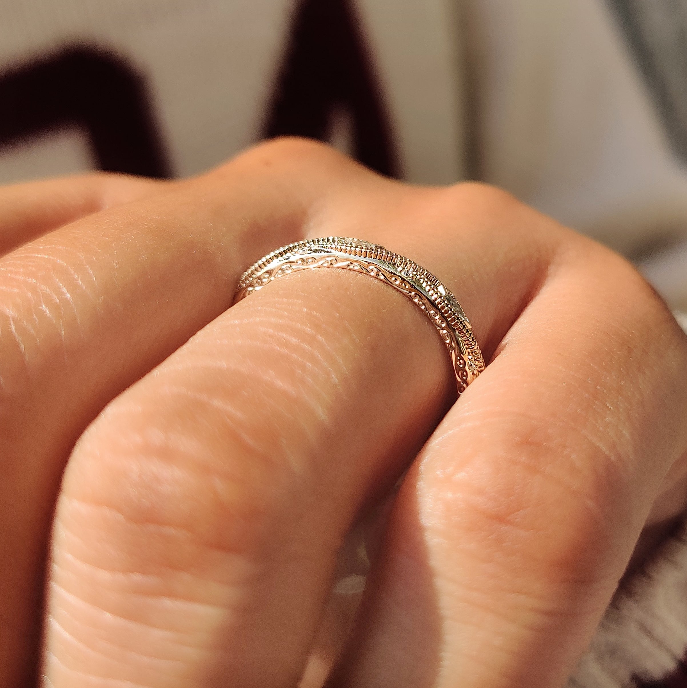 Close up of milgrain detailing on a diamond wedding band.

