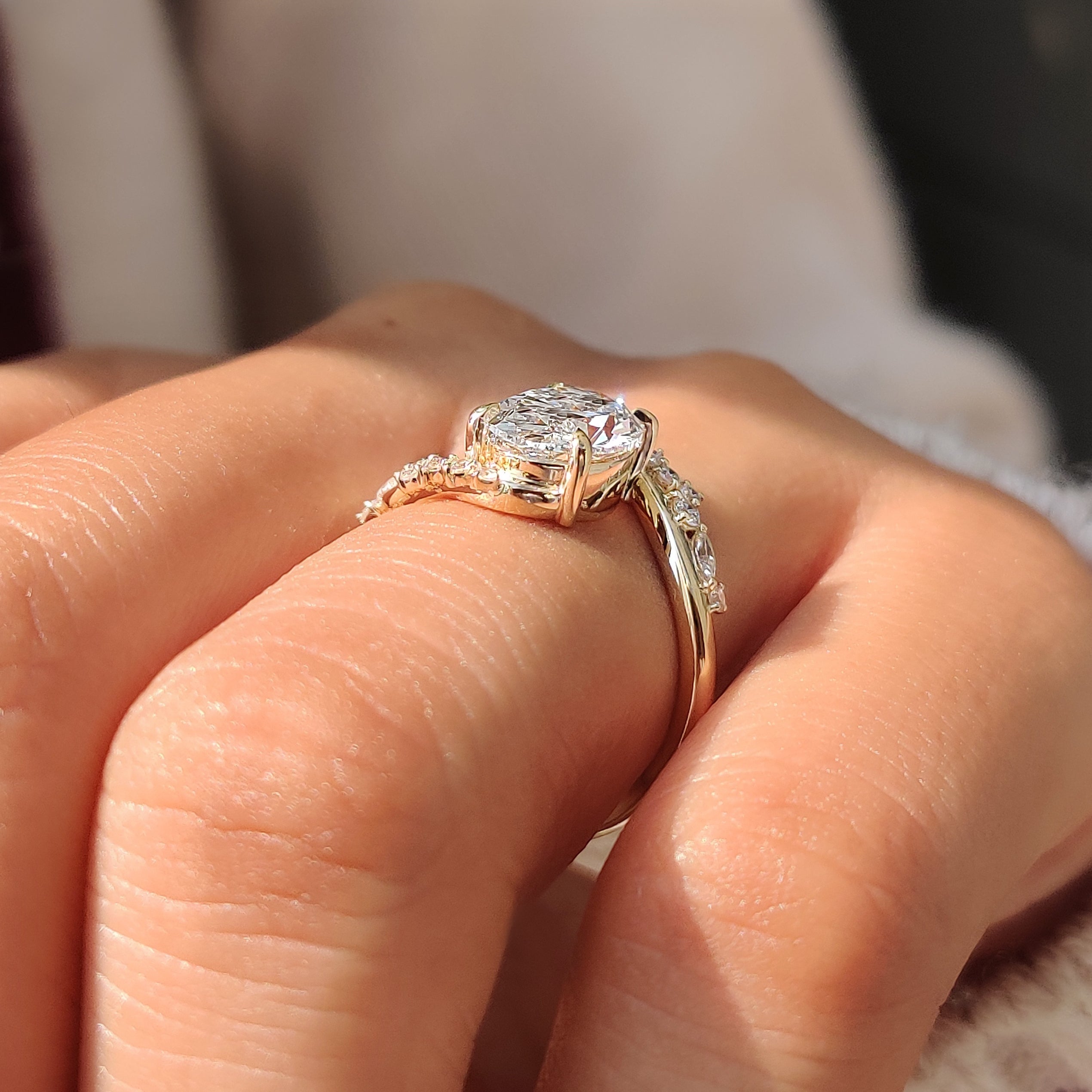 Oval diamond ring with four claw prong setting.
