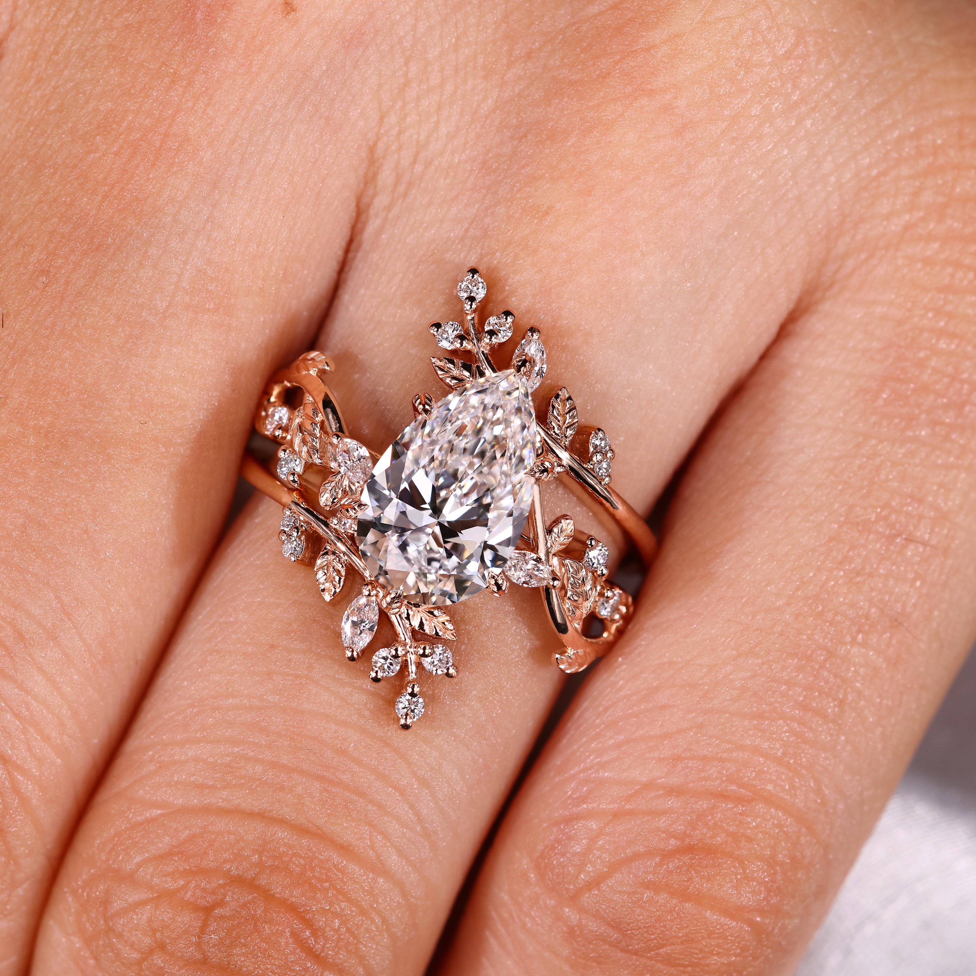 Nature inspired pear ring with leaf style prong setting
