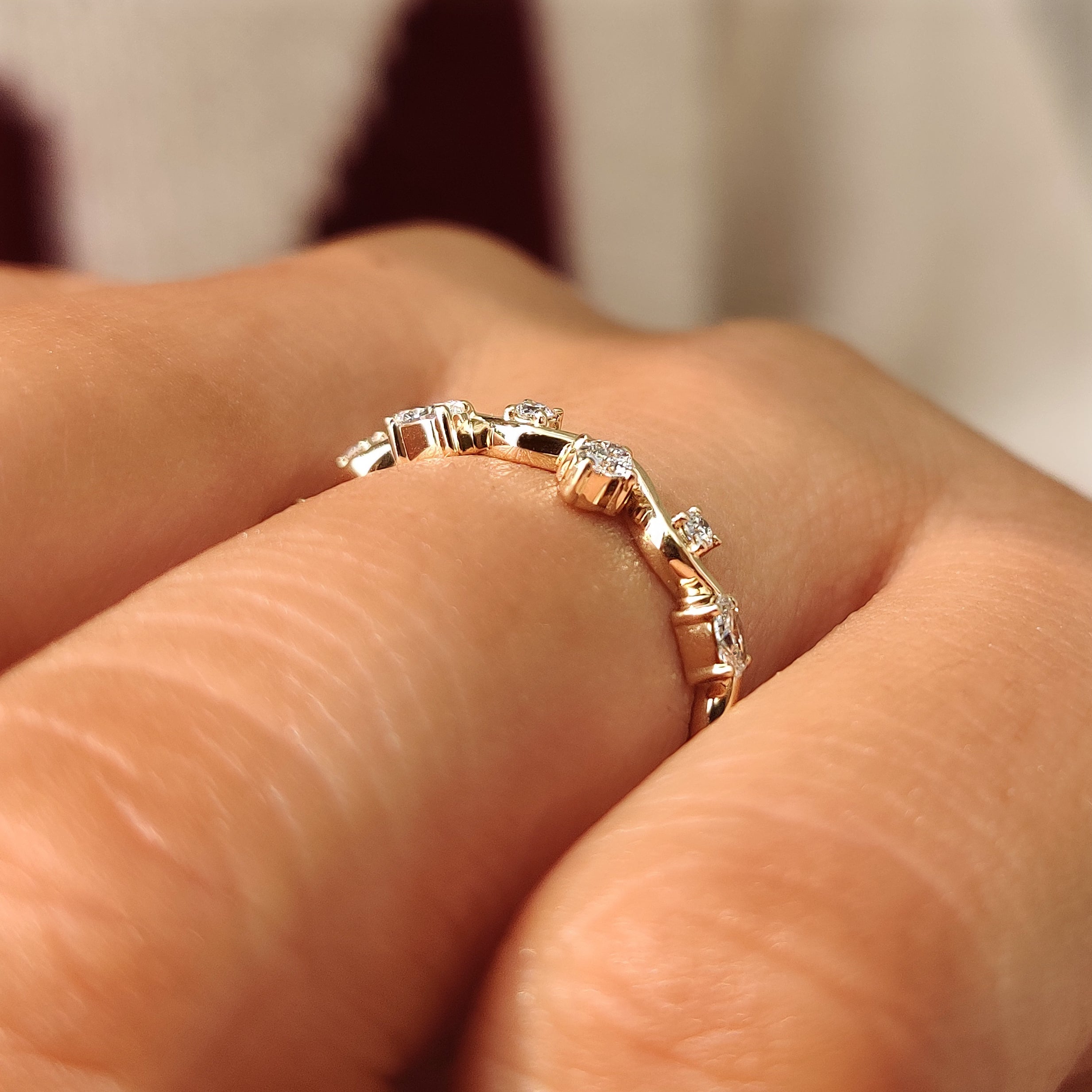 Floating four prong settings holding oval and round diamonds.
