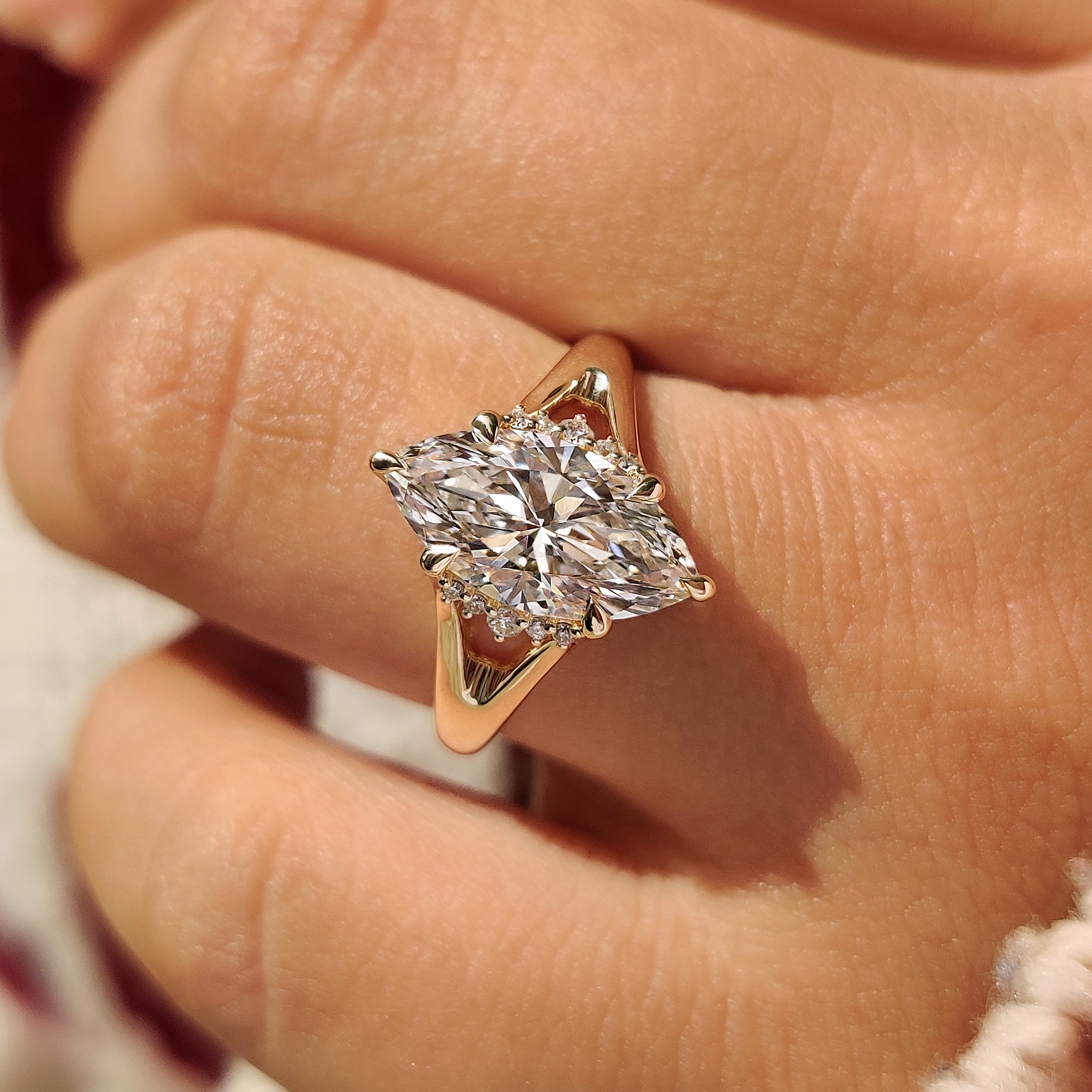 Marquise diamond ring with round side stones and ruby