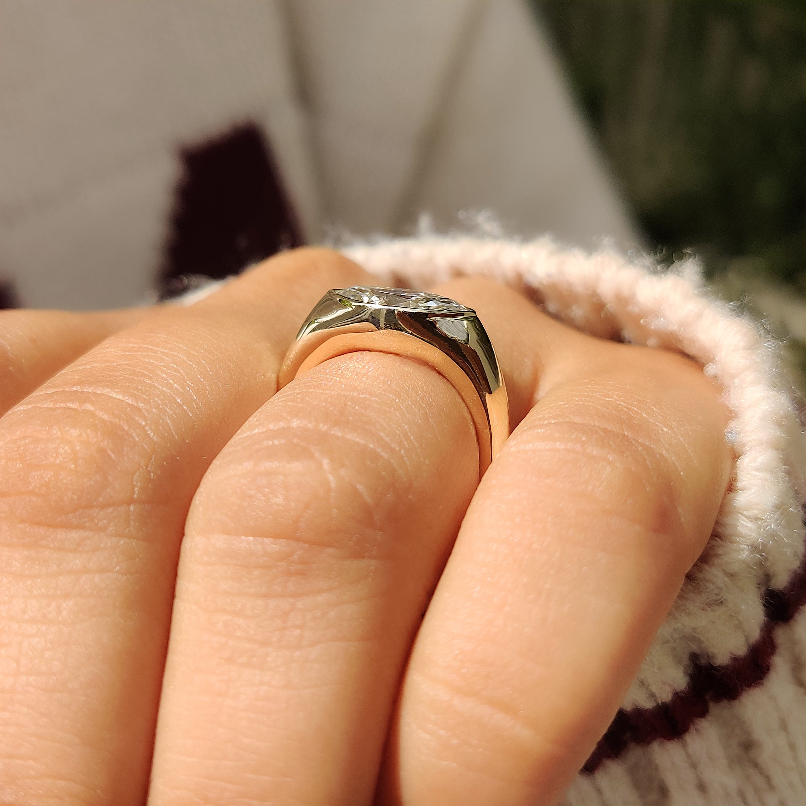 Wide band marquise ring with bezel setting

