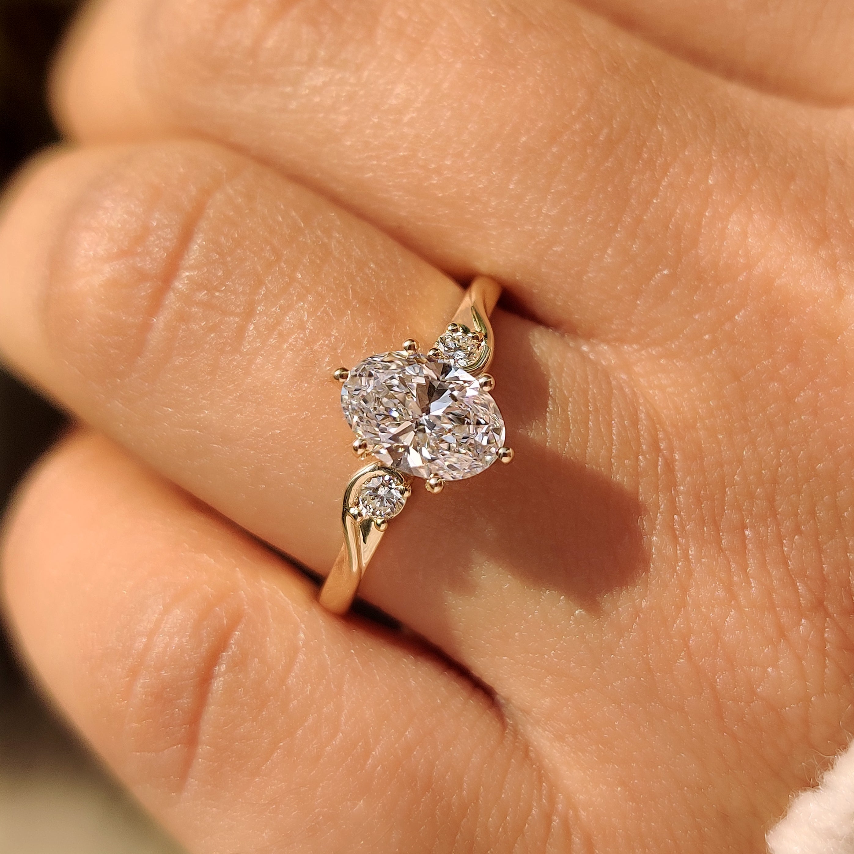 Lab grown oval diamond ring with six claw prongs
