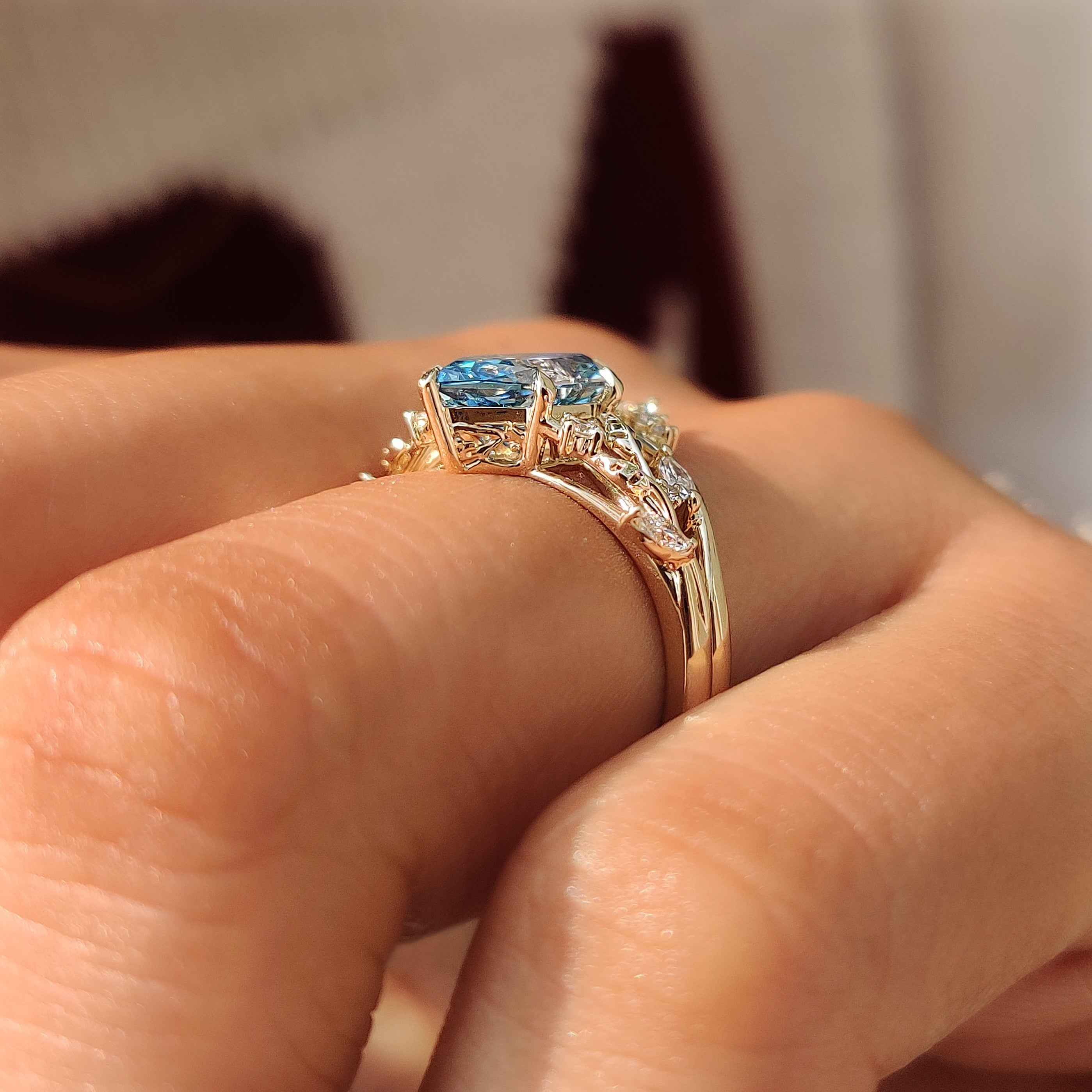 Curved V shaped wedding band paired with blue Dutch marquise ring.
