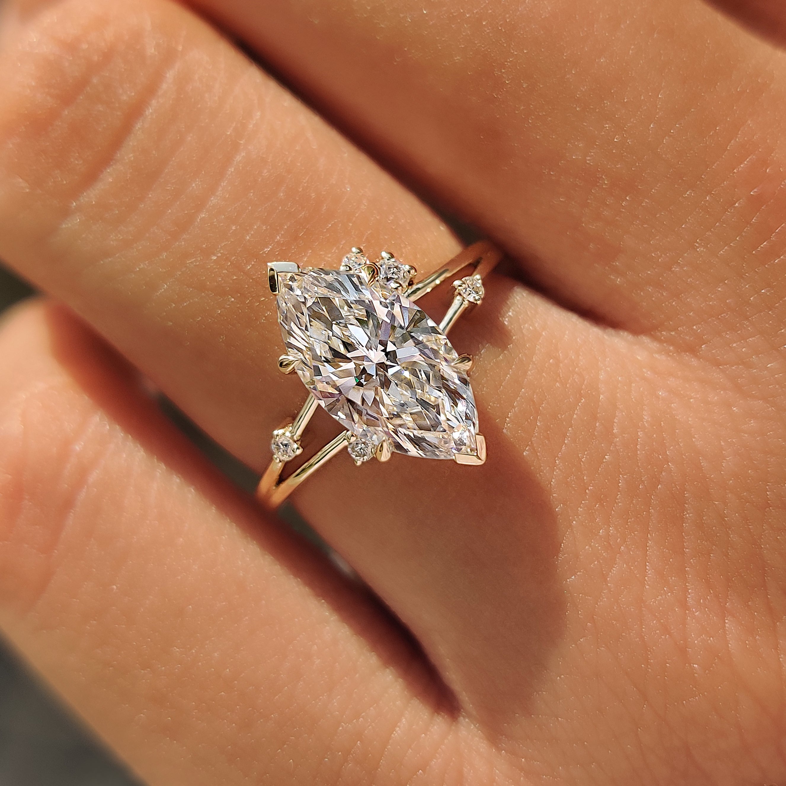 Four claw prong setting on a marquise diamond engagement ring.
