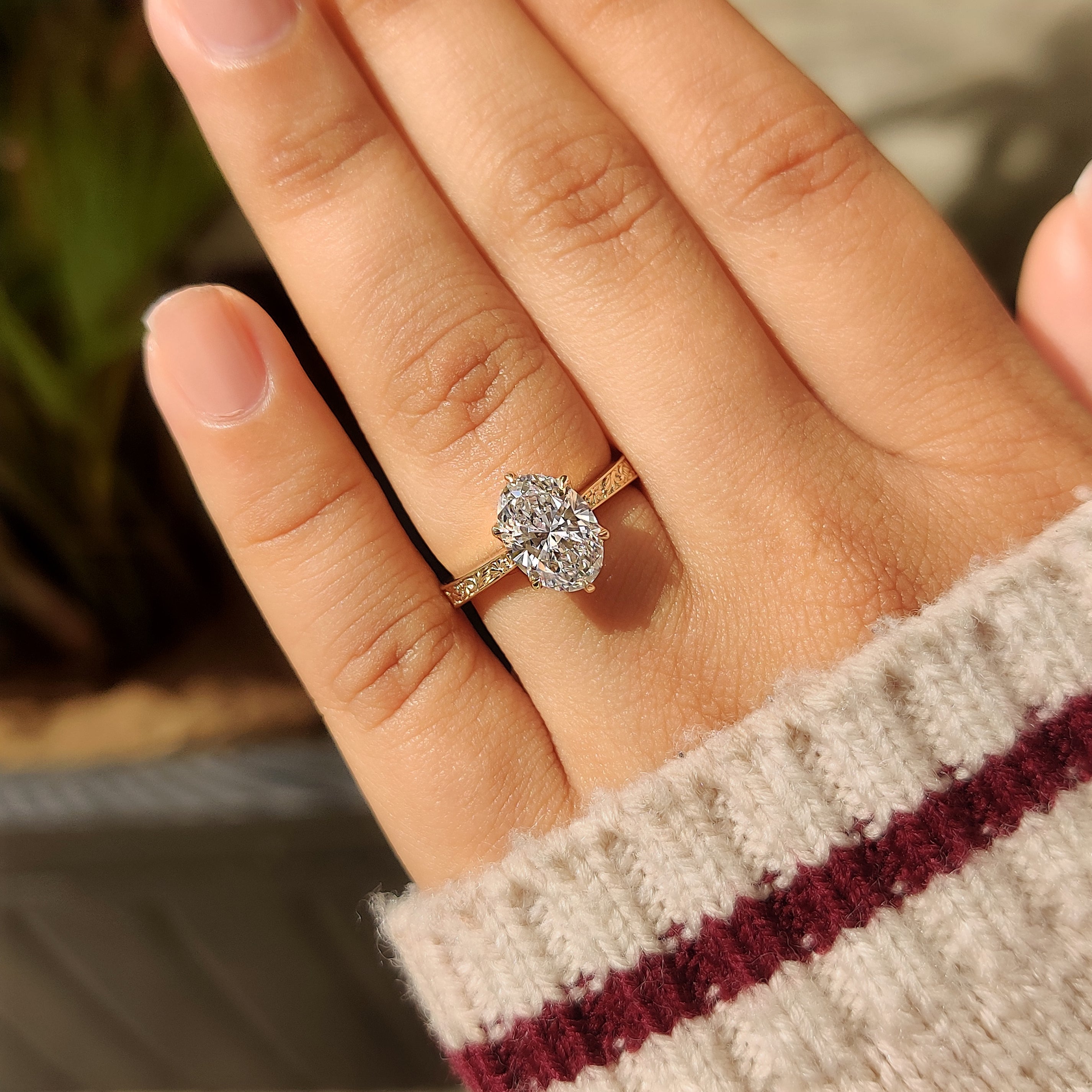 Oval solitaire diamond ring with pink ruby hidden accents

