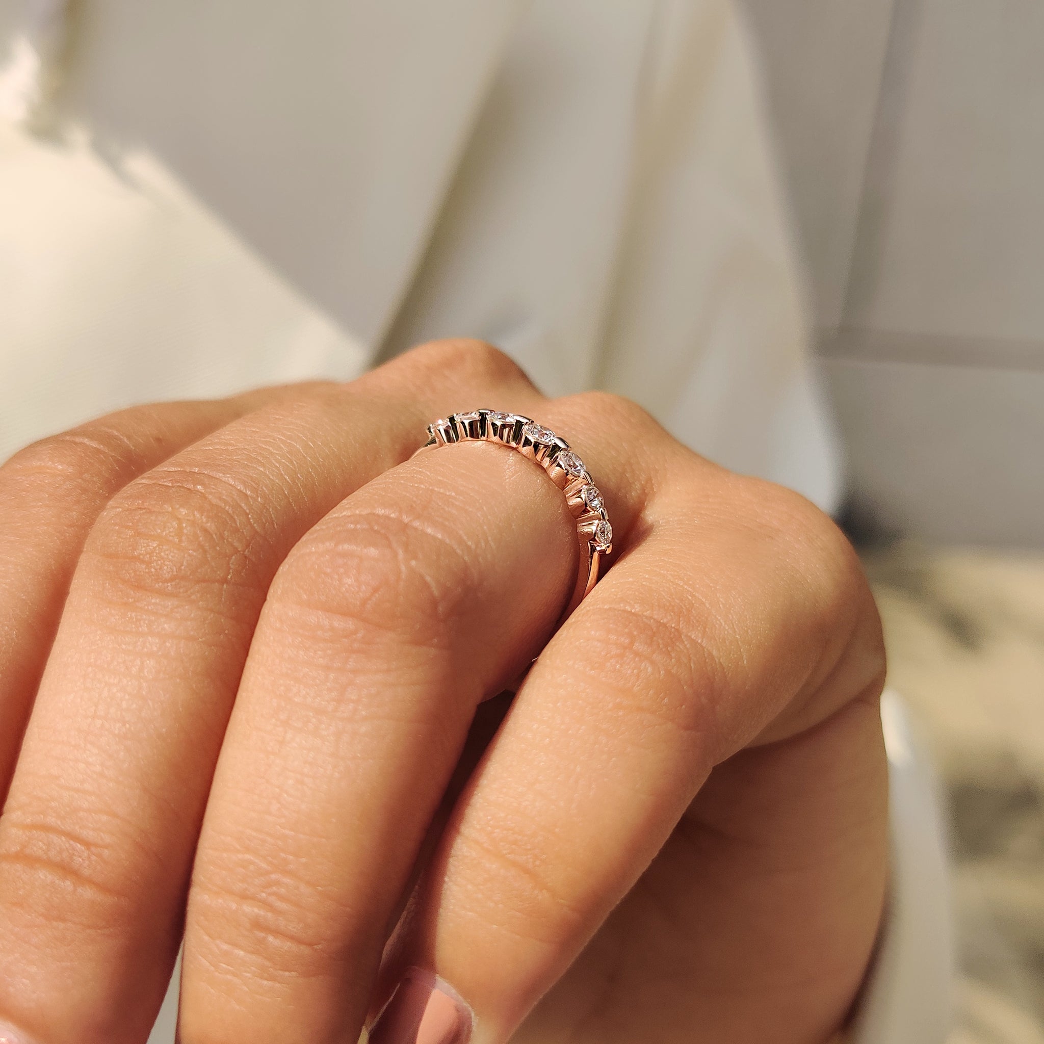 Seven stone diamond band with half eternity style setting.

