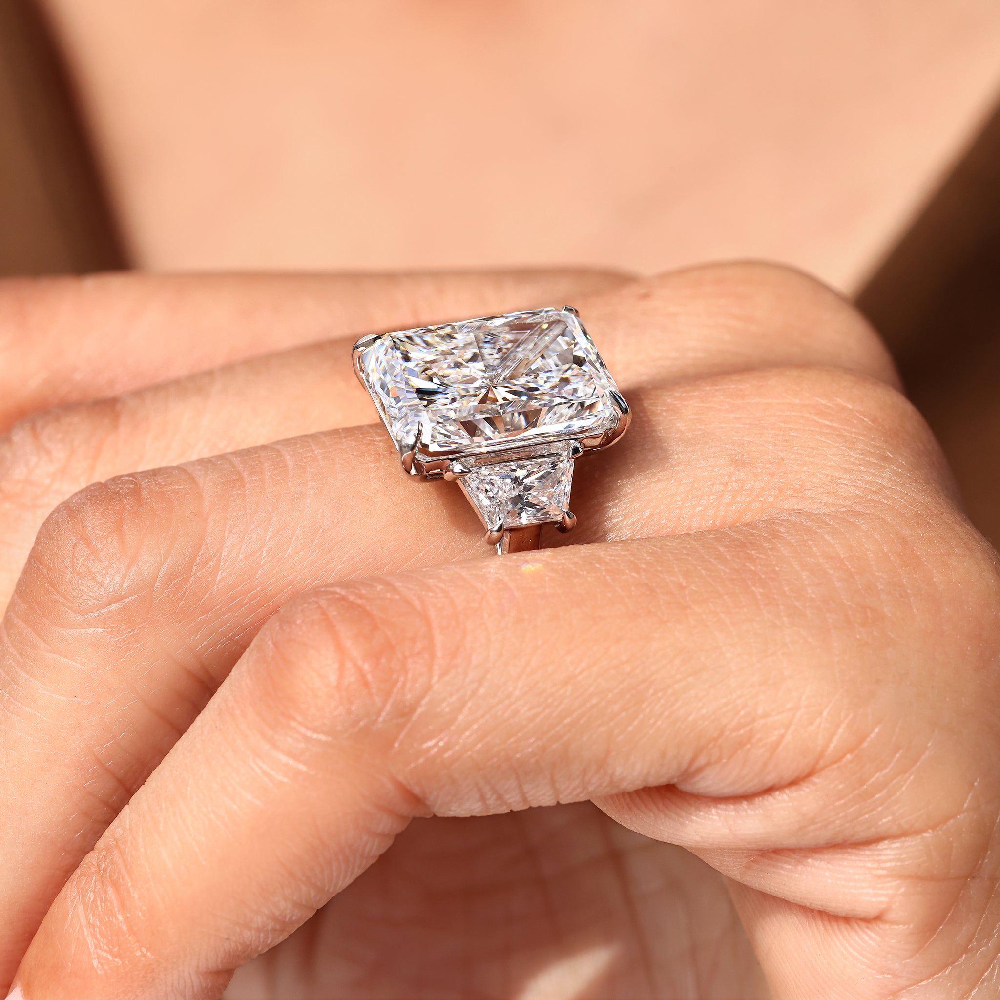 Radiant cut diamond ring with secure four claw prong setting.
