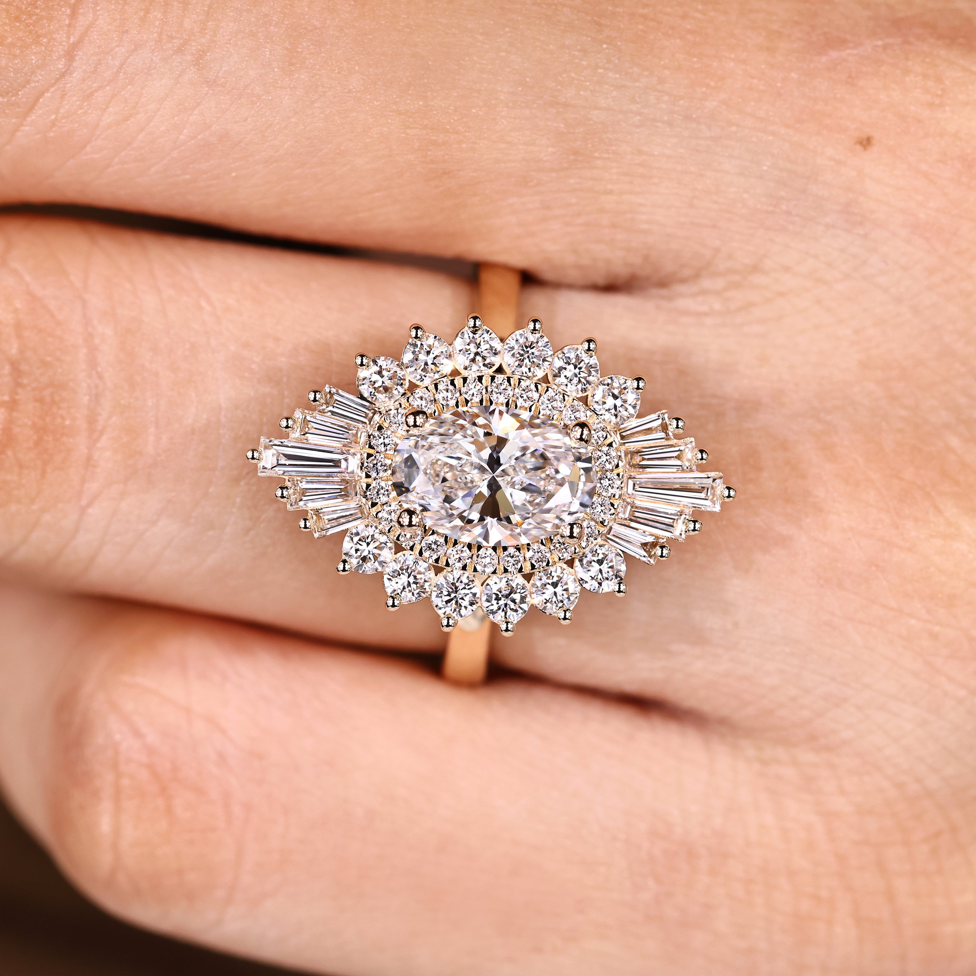 Oval diamond ring with four prongs and halo design
