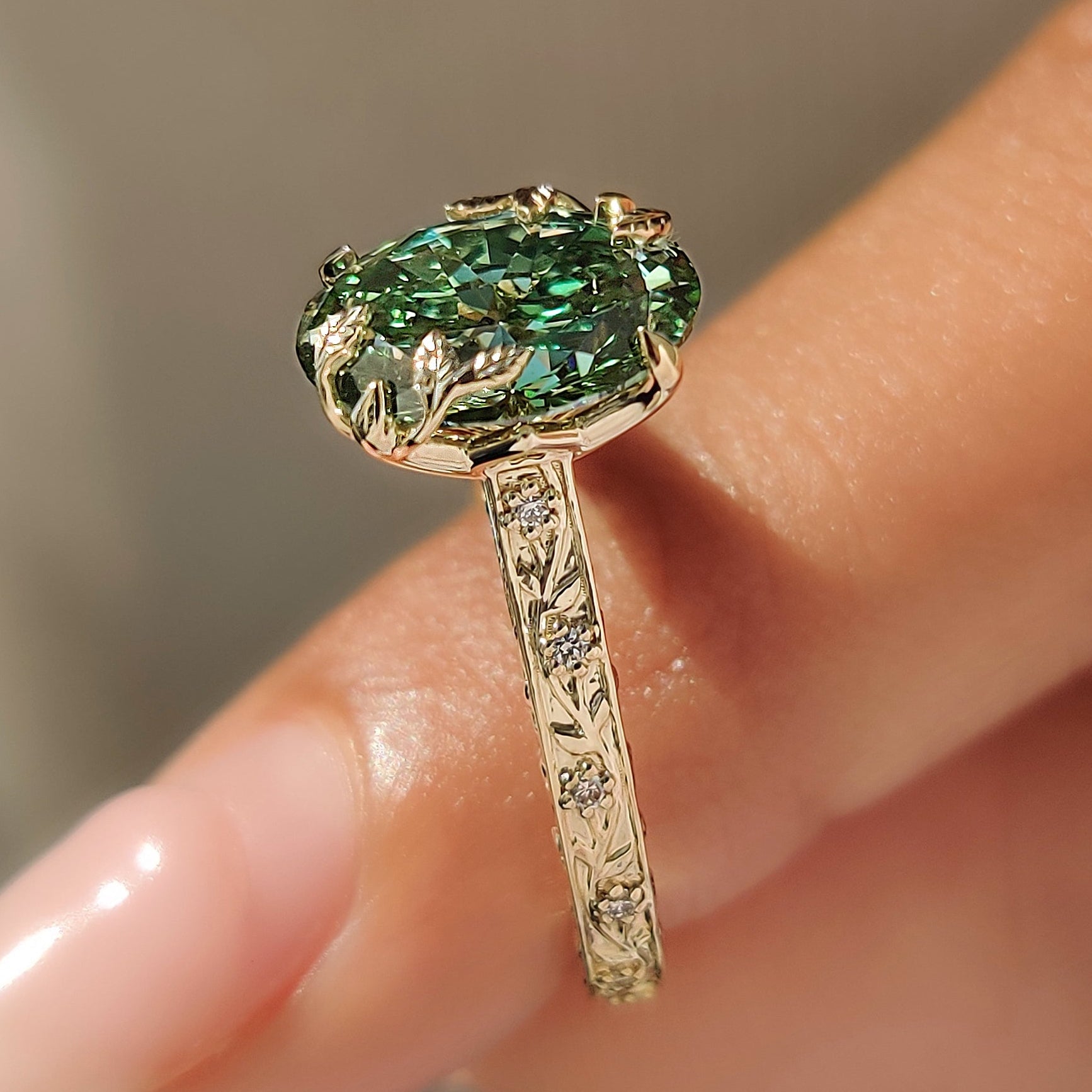 Vintage design with a green oval center diamond.
