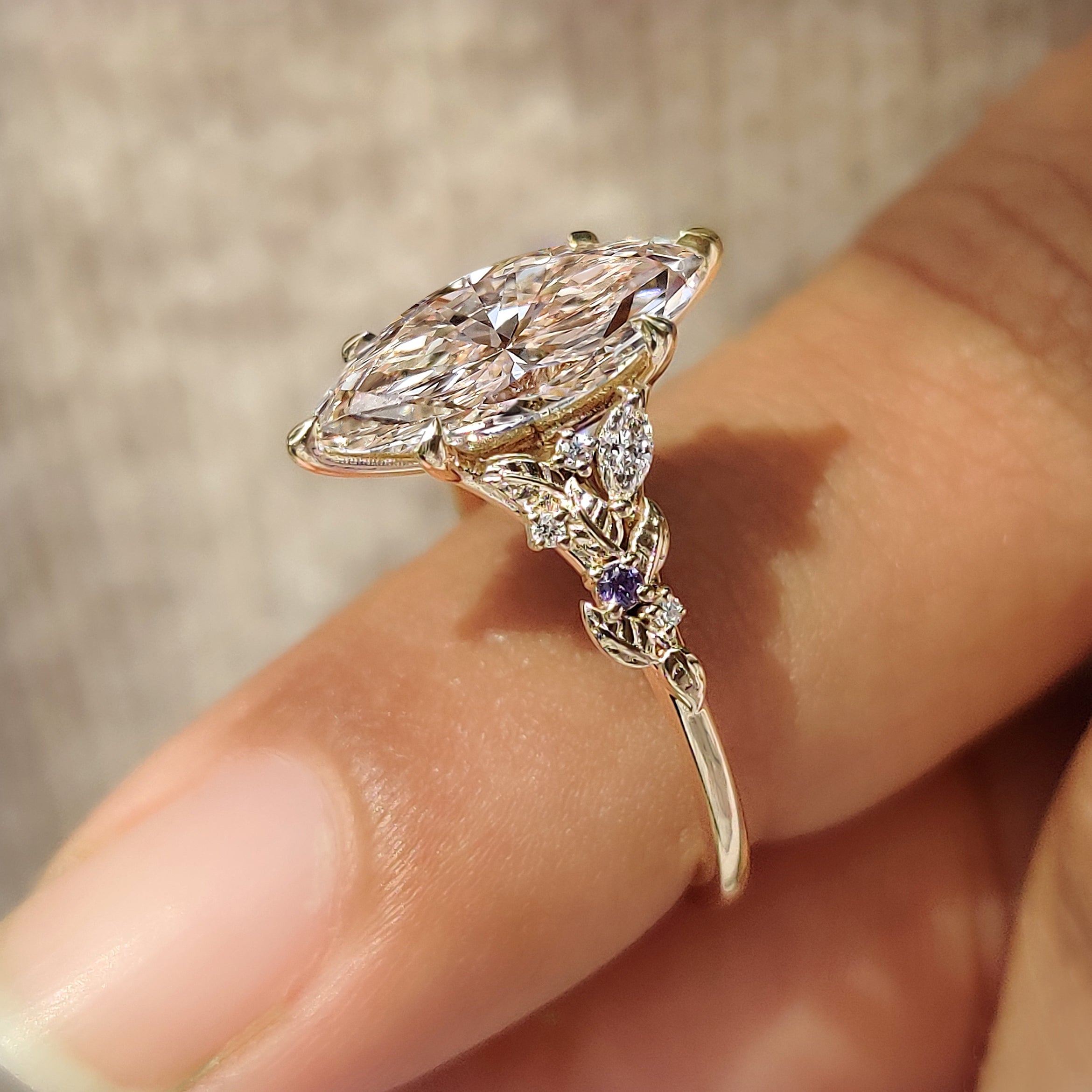 Marquise ring with round amethyst side stones
