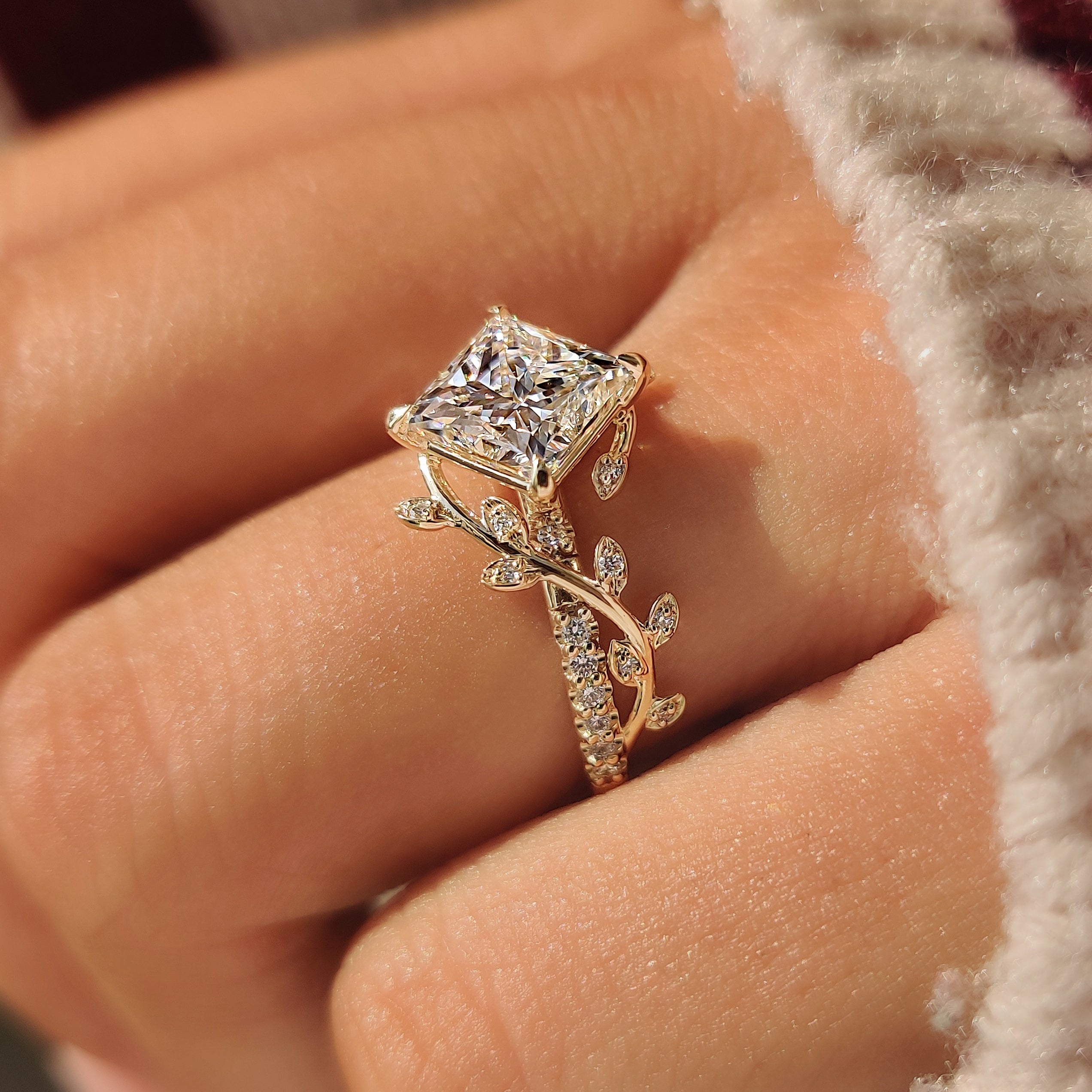 Princess cut lab grown diamond ring with leaf details.
