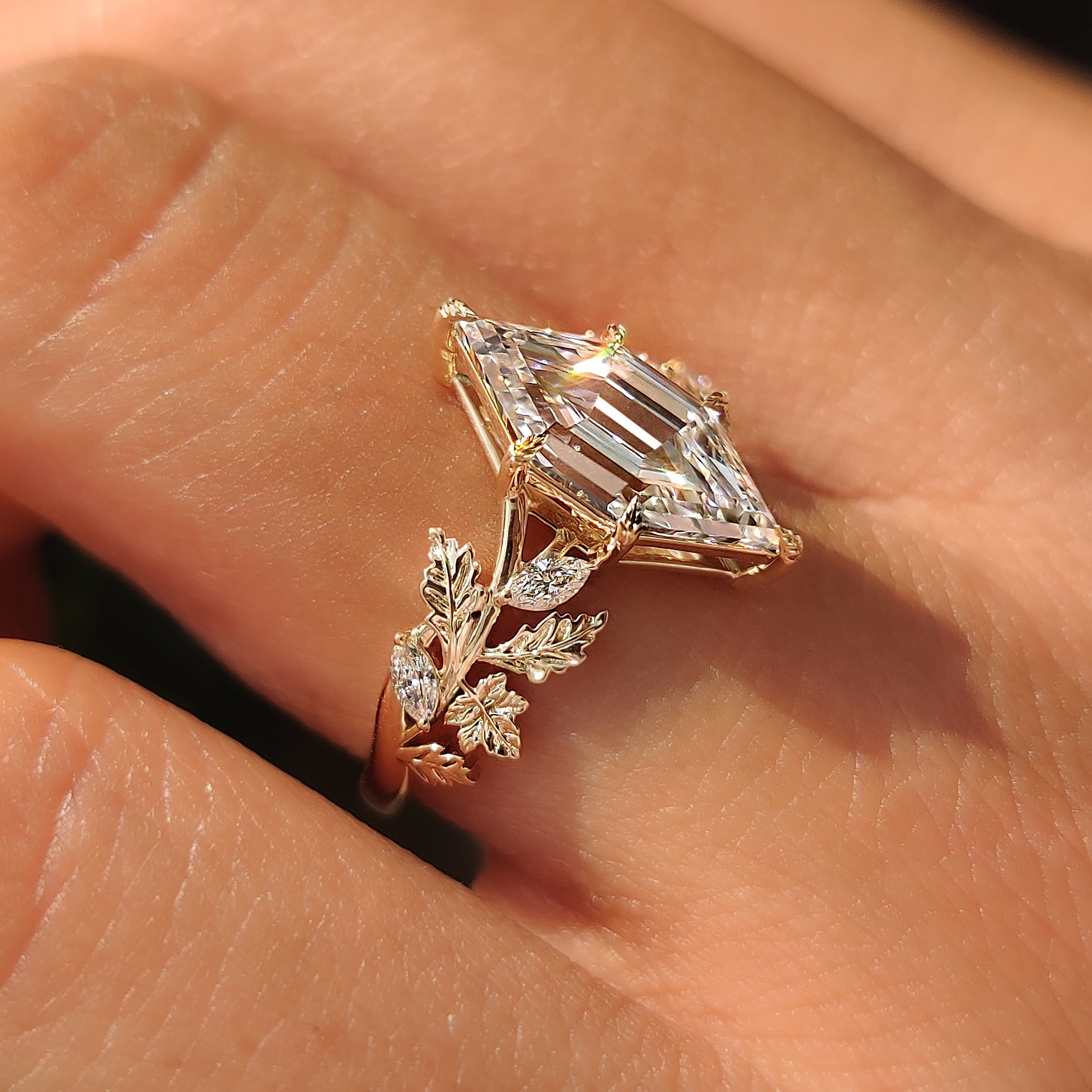Close up of the hexagon step cut diamond and marquise accents.
