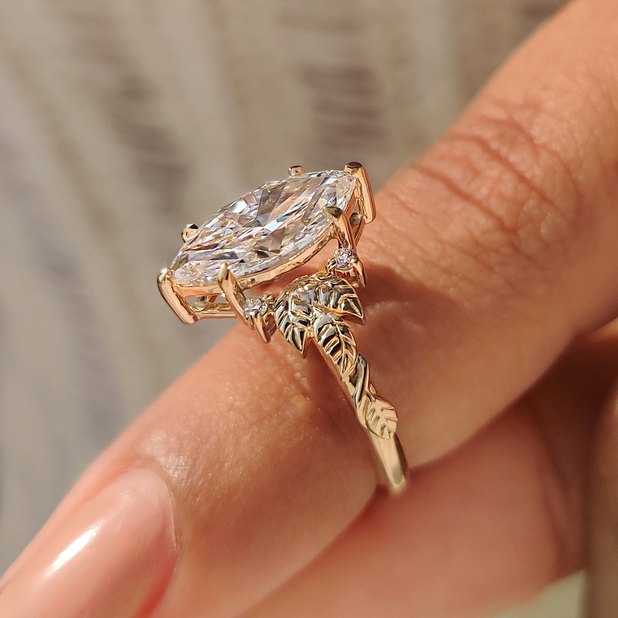 Six claw prong marquise diamond ring with nature leaf design.
