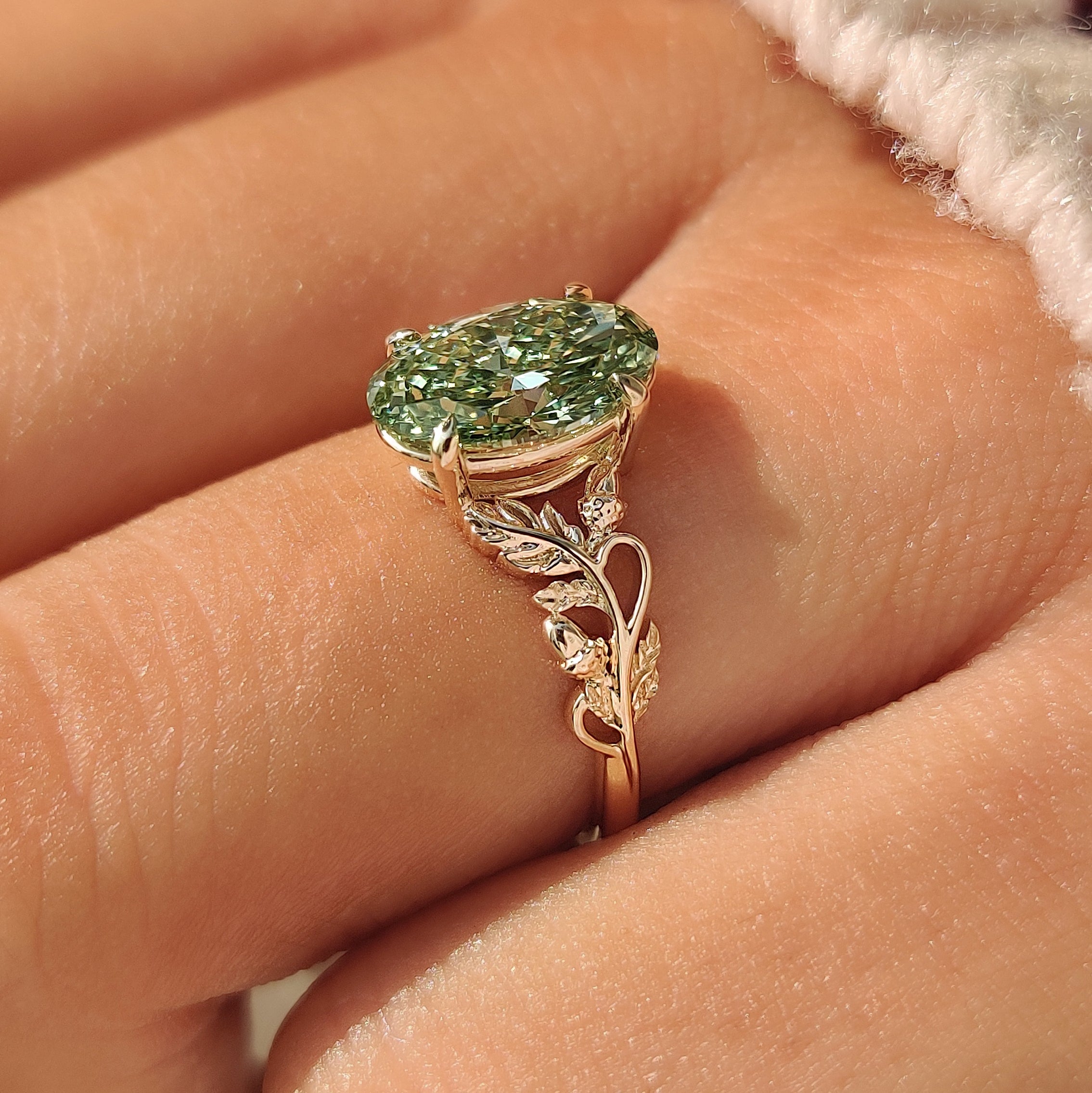 Nature inspired engagement ring with curved vine detailing.
