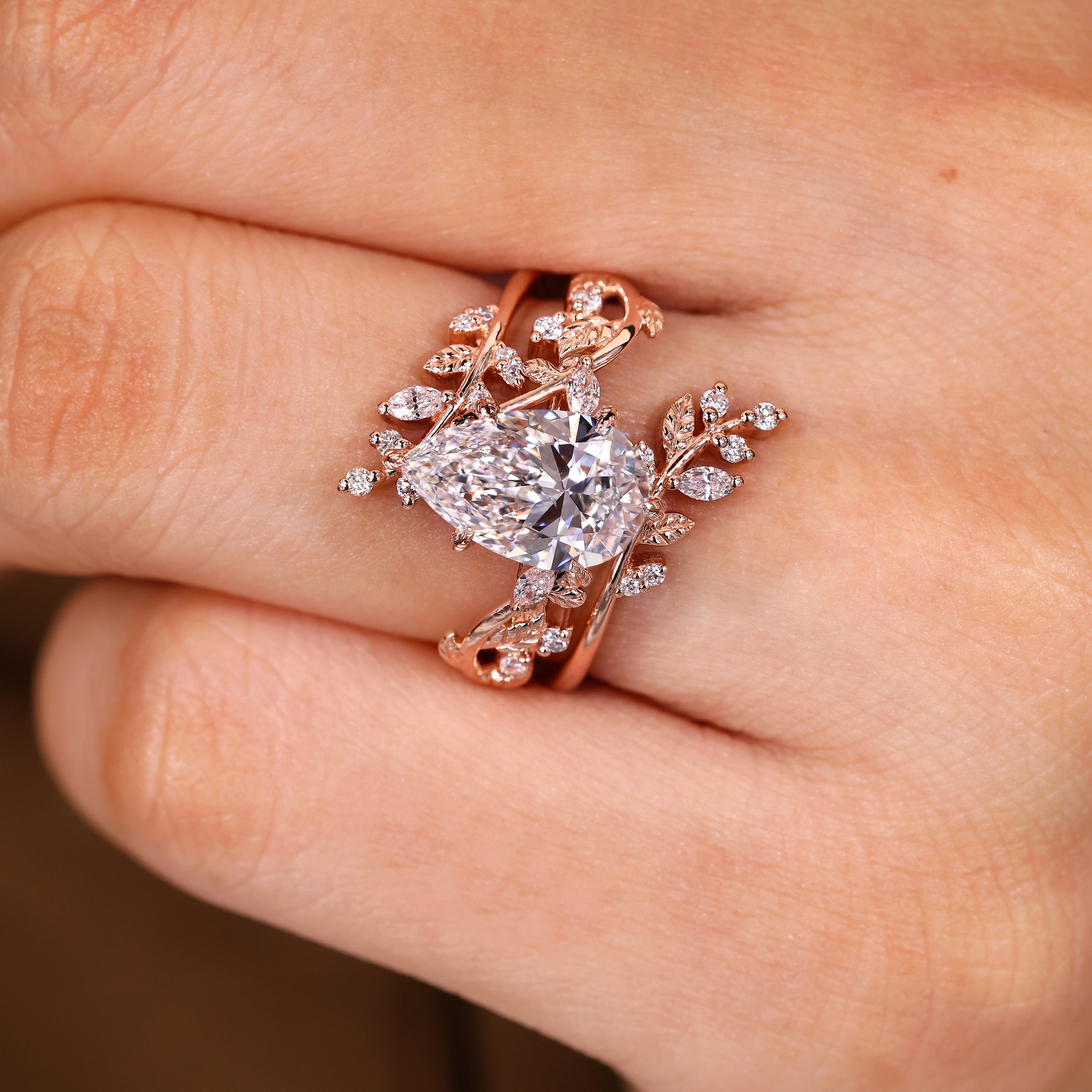 Pear shaped diamond ring with cluster side stone design
