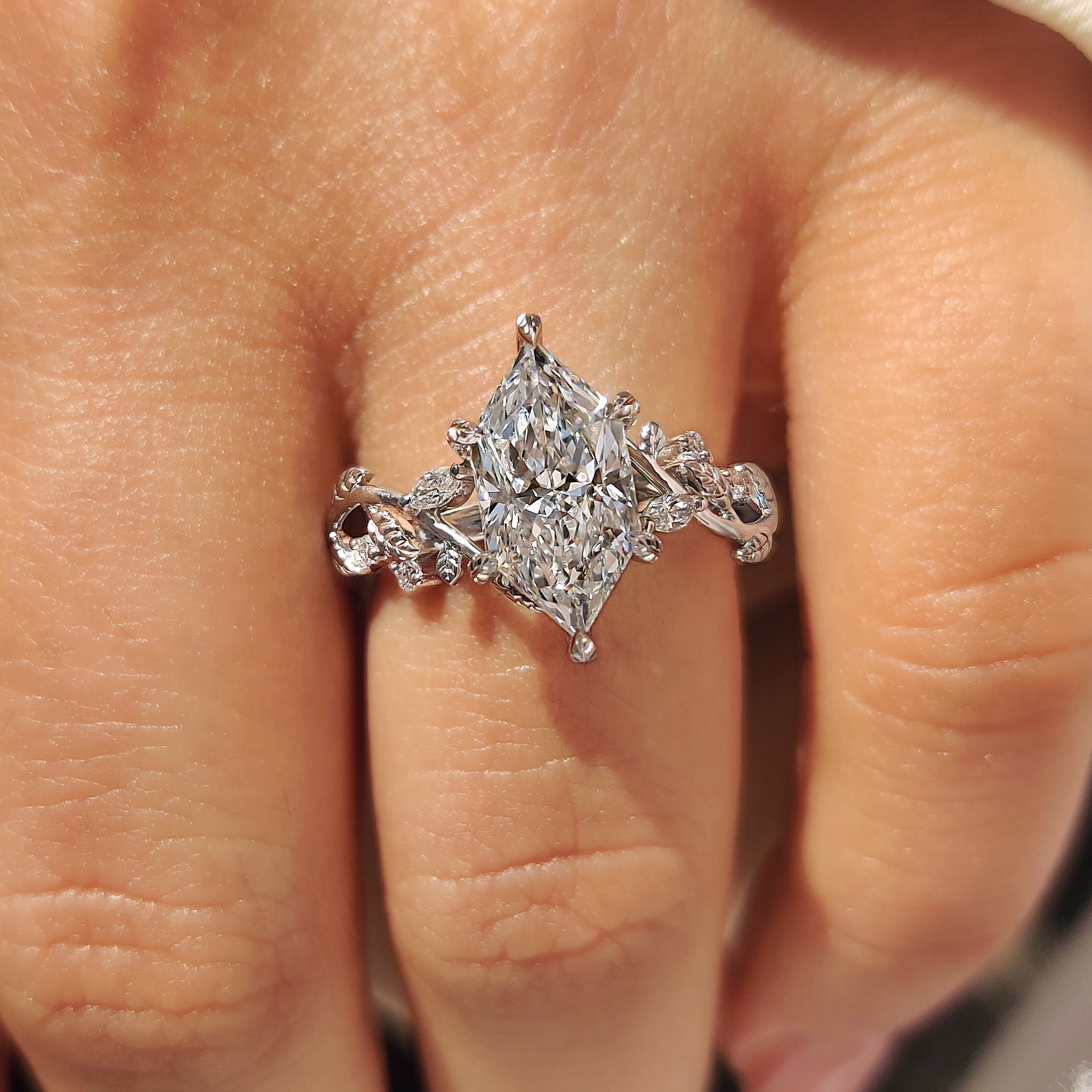 Handmade marquise lab diamond ring with leaf style prongs.
