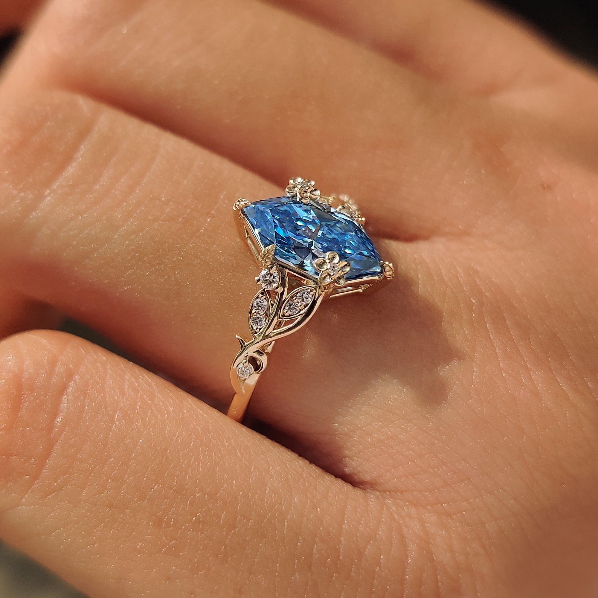 Lab grown blue Dutch marquise diamond ring with round side stones.

