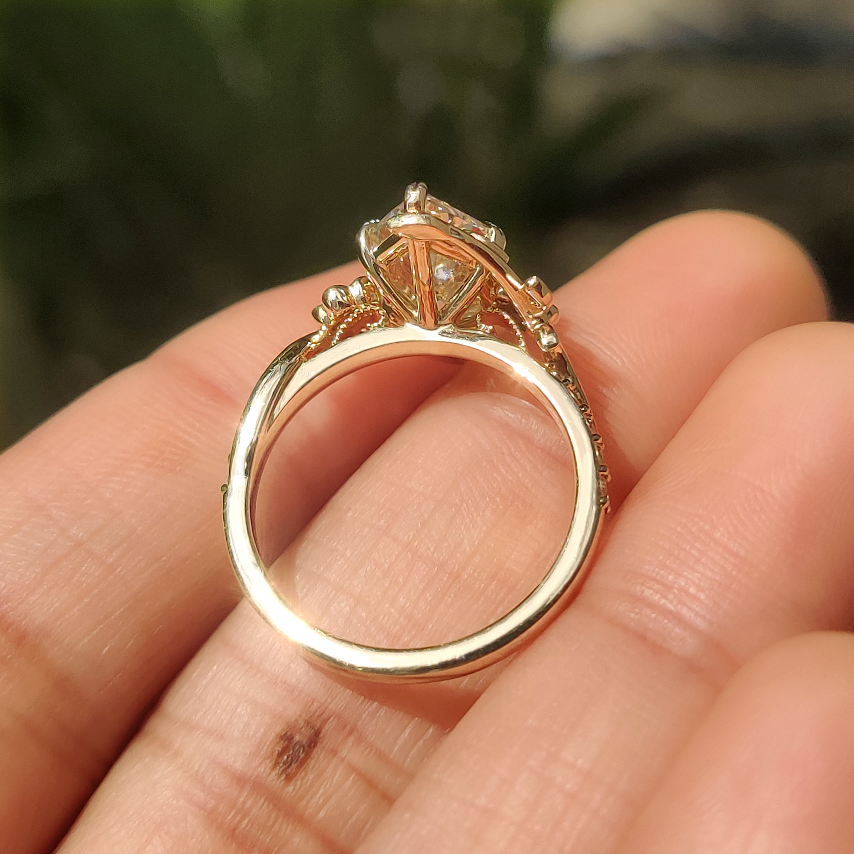 Round blue sapphire accents beside center diamond
