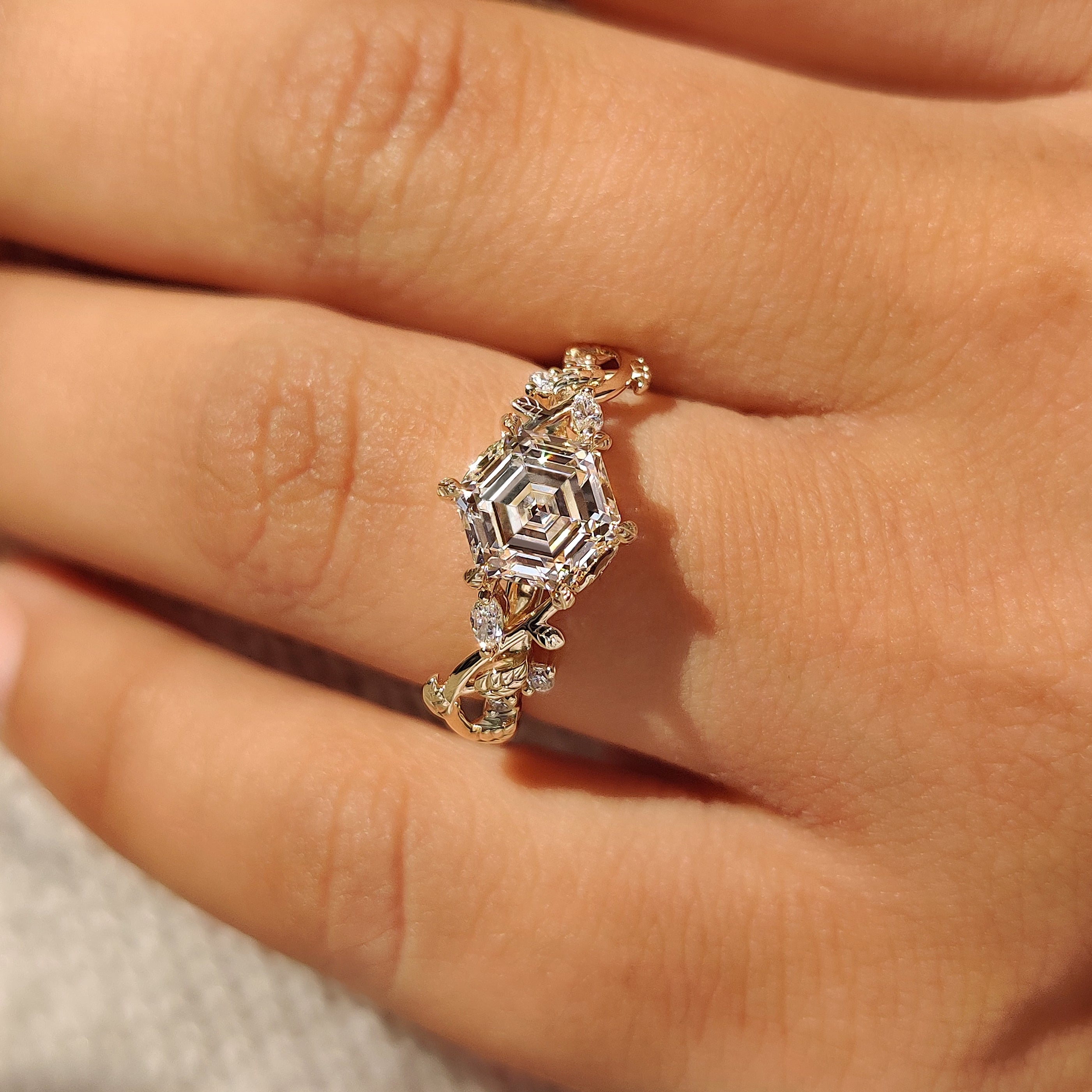 Hexagon engagement ring with cluster setting and leaf details
