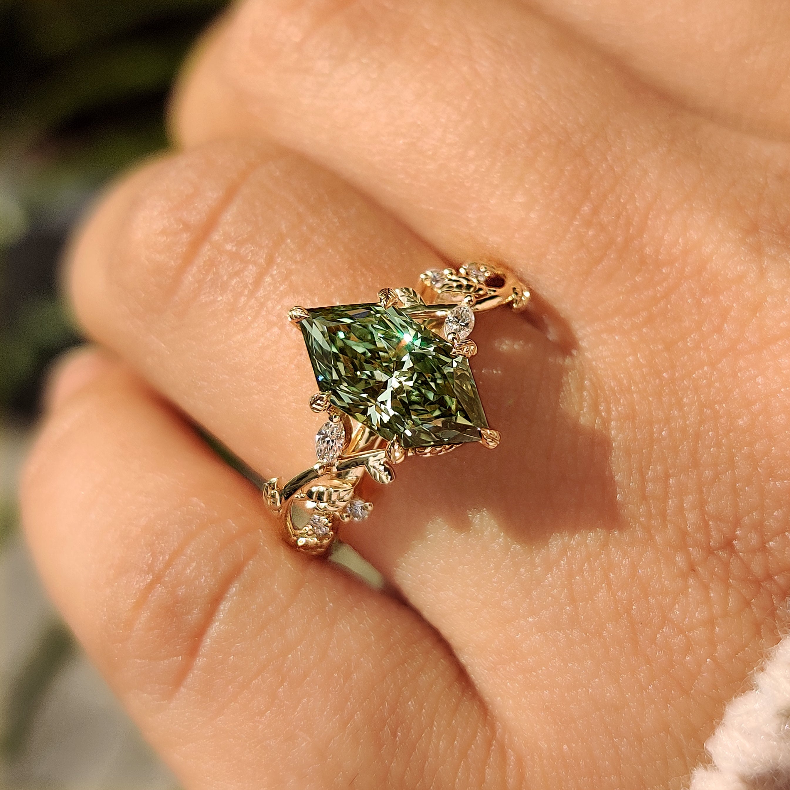Green center diamond ring with nature inspired leaf details

