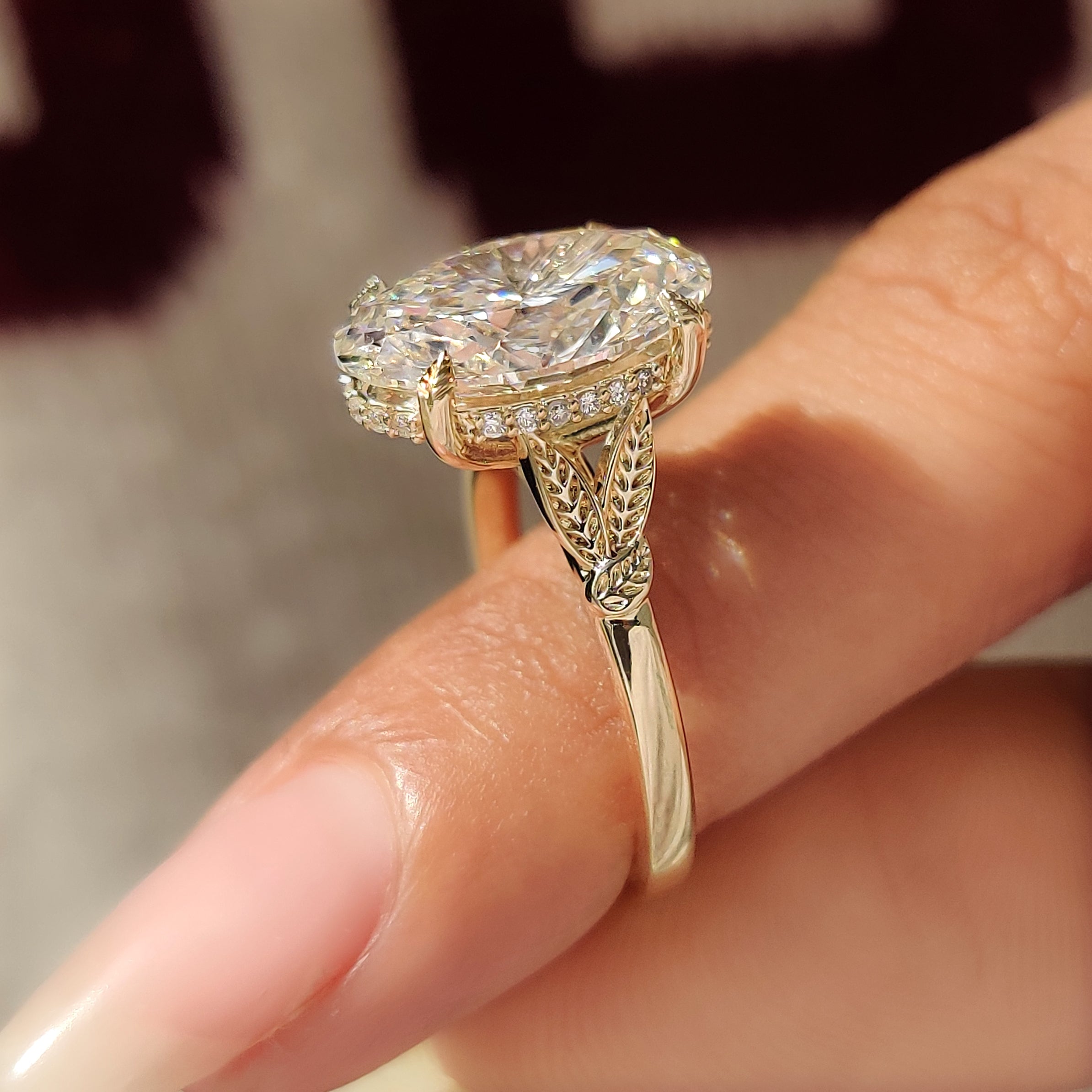 Split shank solitaire engagement ring with leaf details
