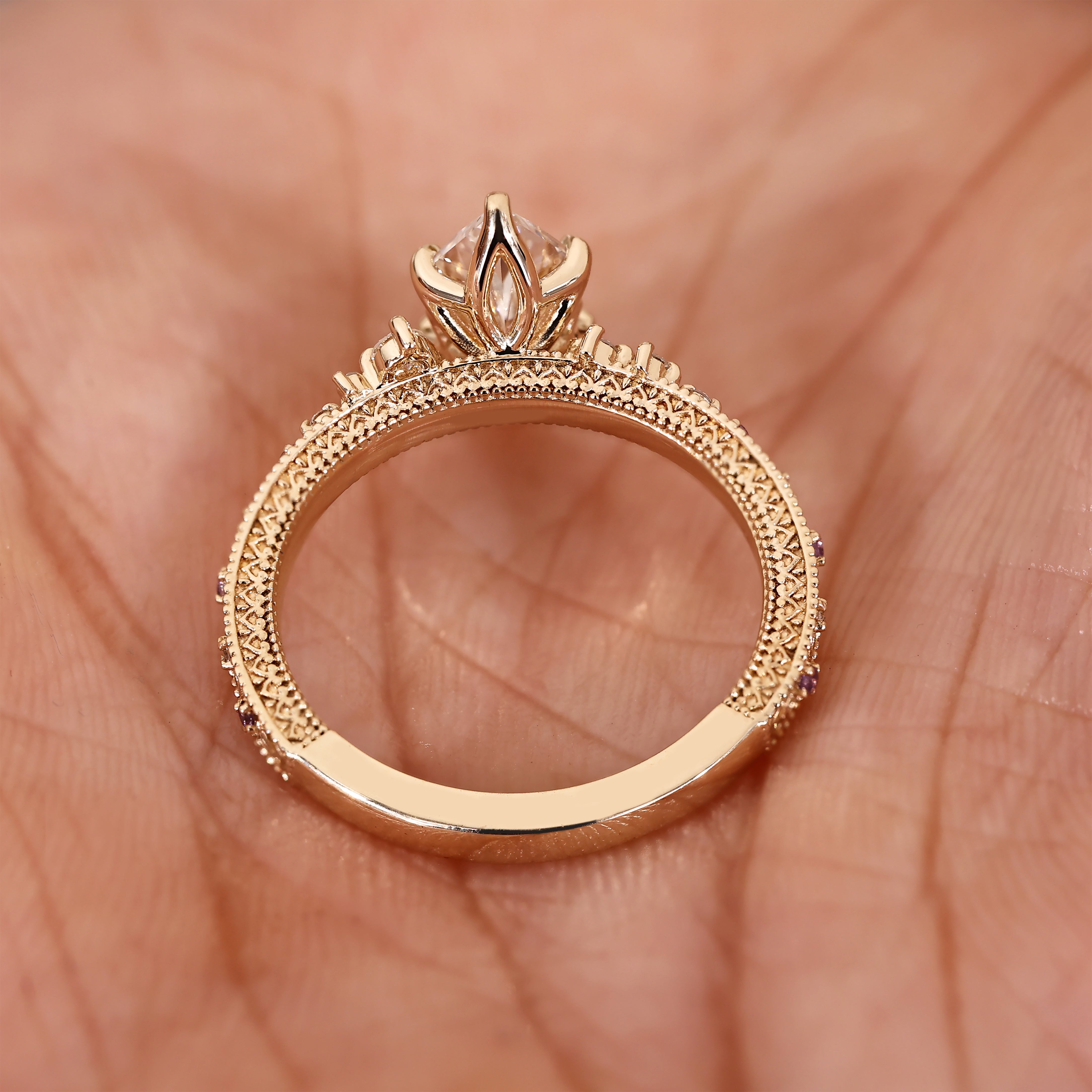Round side stones with round amethyst accent stones in dutch marquise ring
