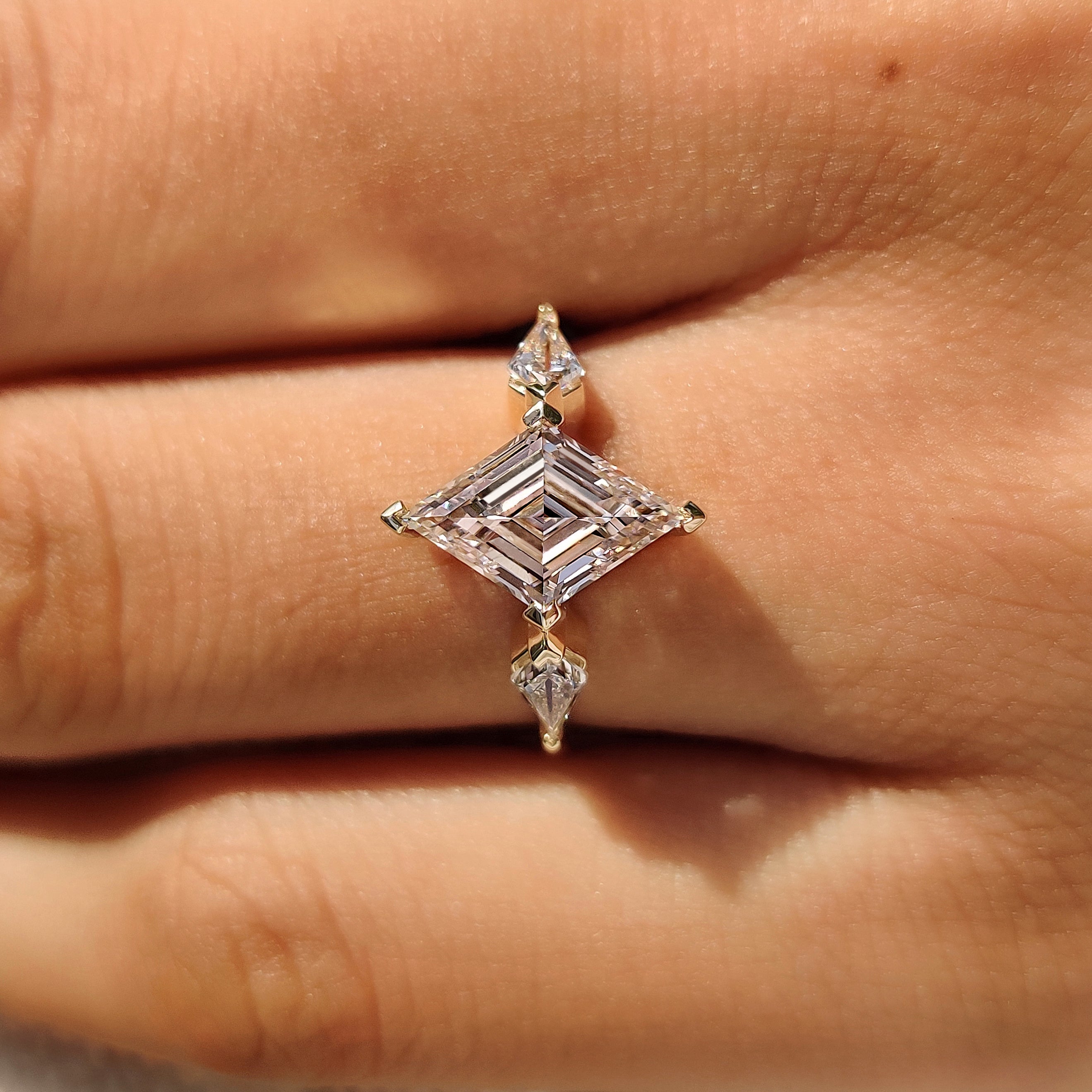 Handmade lozenge cut ring with kite side accent stones
