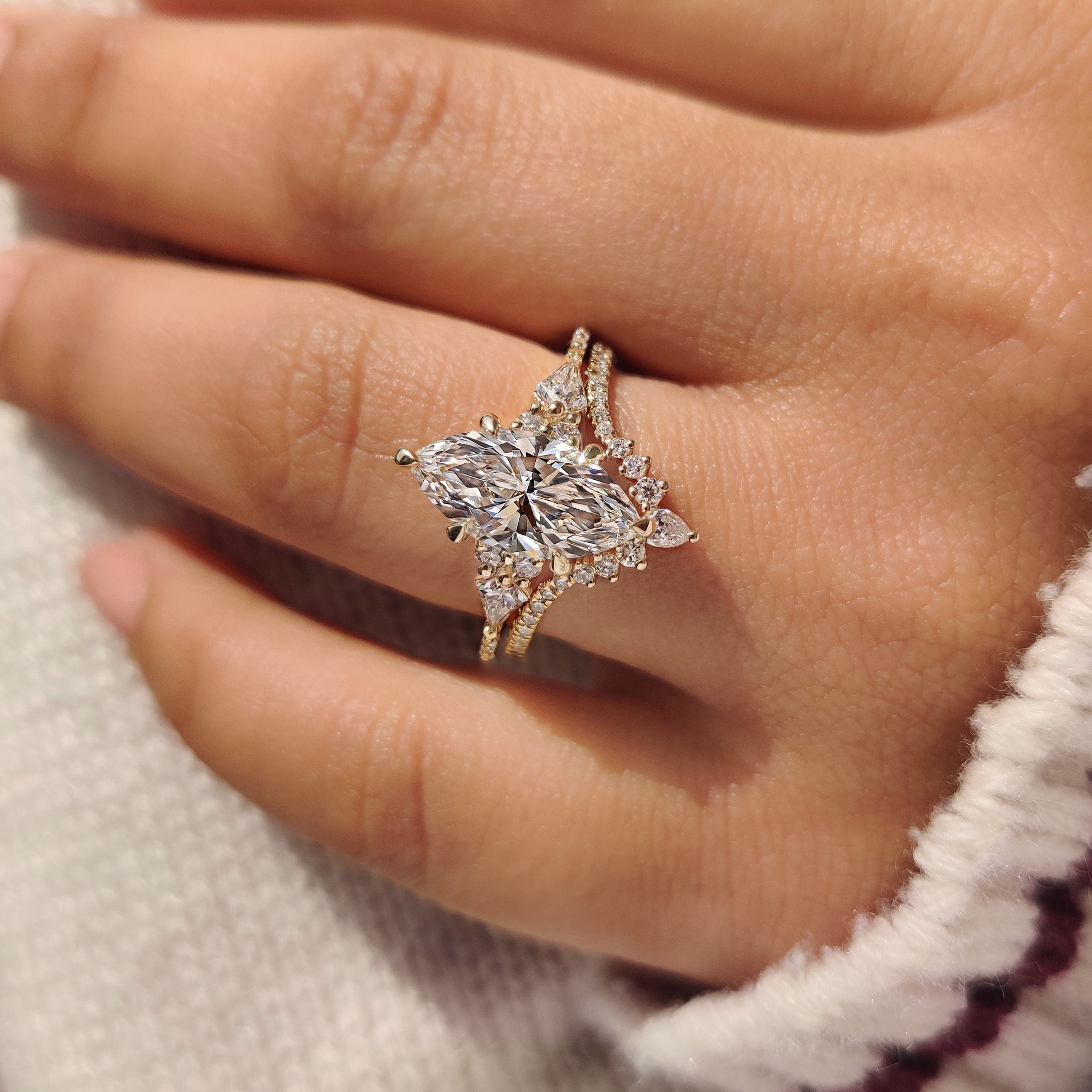 Lab grown marquise ring with round diamond curved band.
