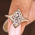 Marquise cut diamond engagement ring with solitaire bezel setting.
