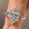 Solitaire diamond ring with marquise cut and split shank.

