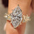 Marquise diamond ring with round side stones and pave band
