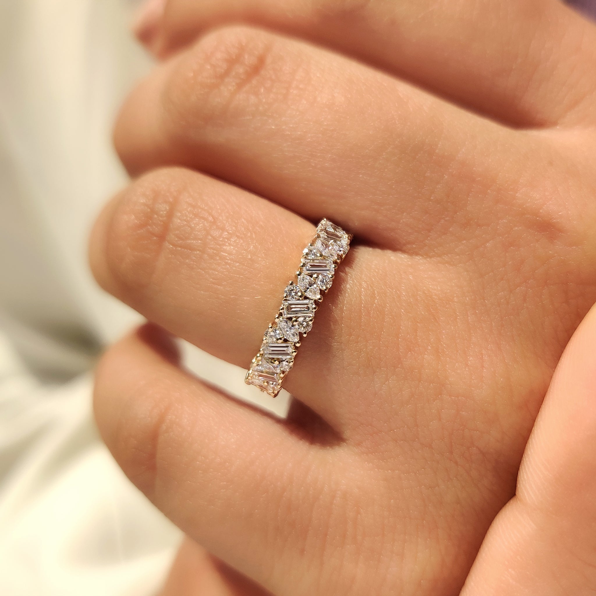 Full eternity ring with marquise round and baguette diamonds.
